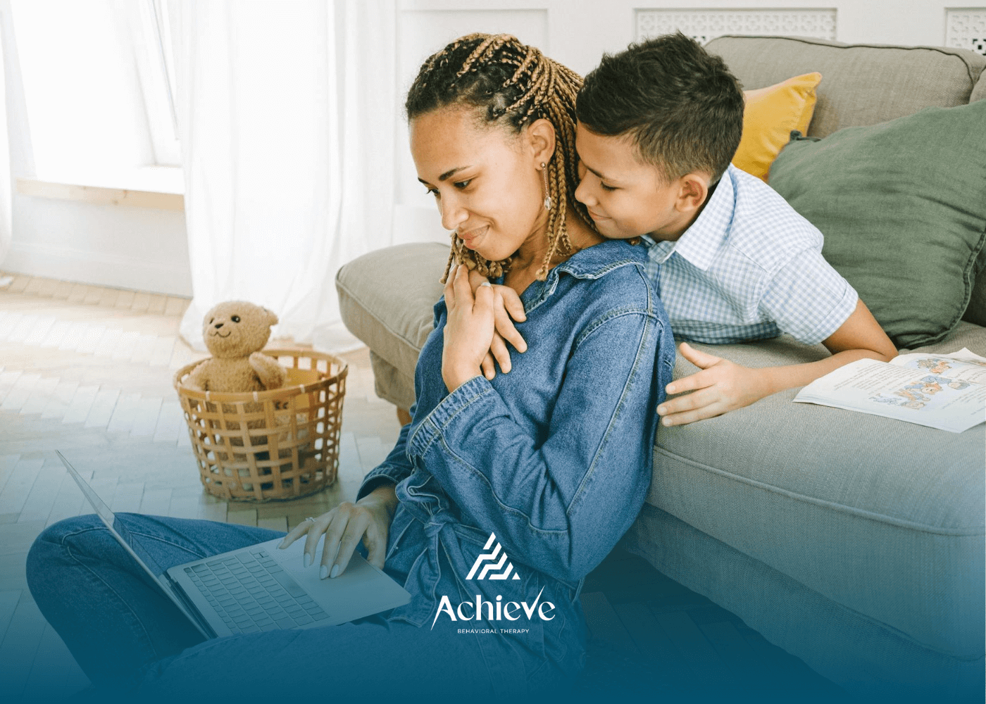 Autistic boy hugging his mother from behind while she works on laptop during ABA therapy in NC.
