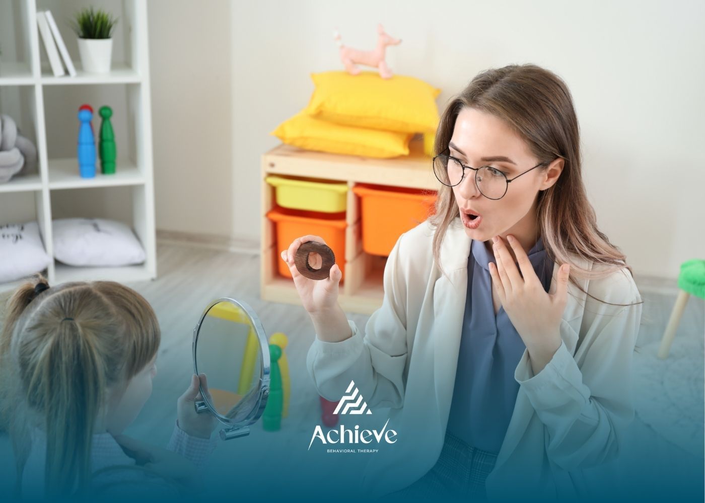 Therapist demonstrating pronunciation to a child using a donut. Playroom setting, neutral colors.