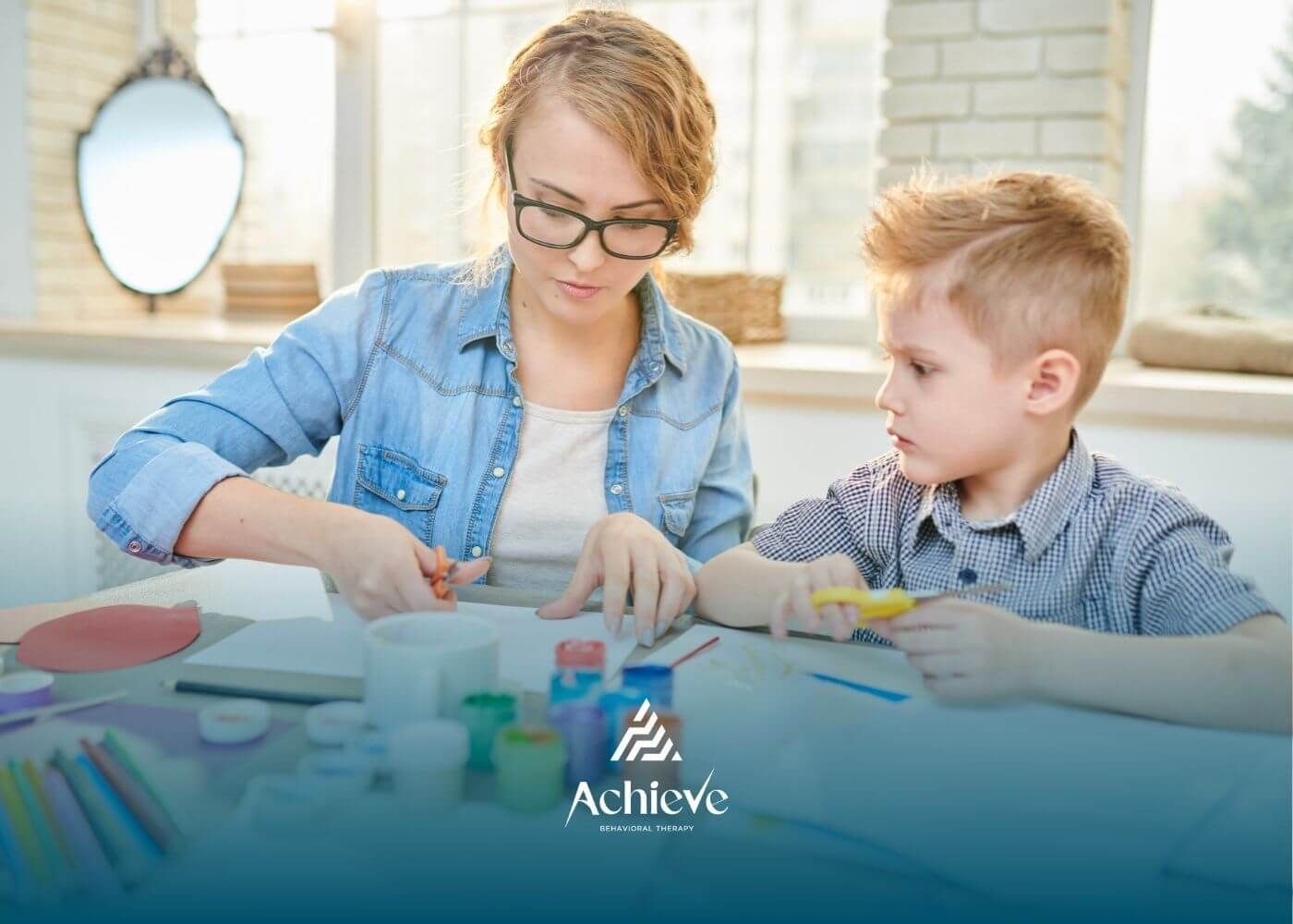 Female BCBA and autistic doing arts and crafts together in ABA therapy.