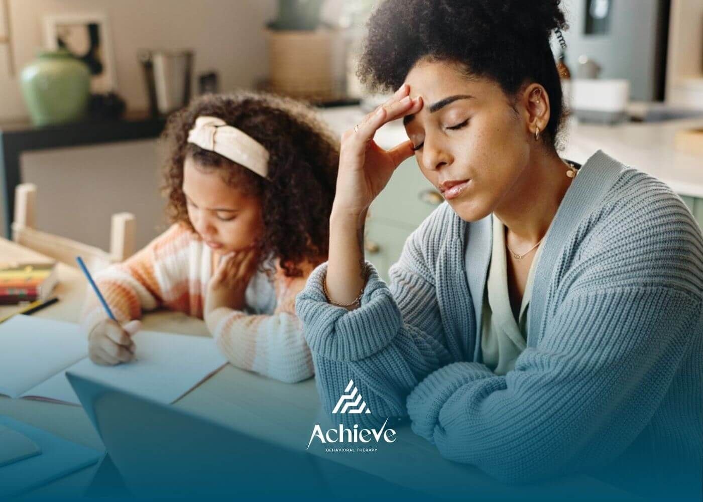 Parent feeling stressed while child with autism does homework at the table.