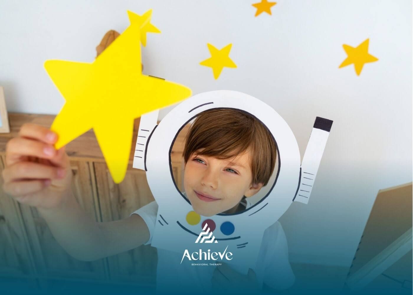 Child with autism wearing a paper astronaut helmet and holding a yellow star.