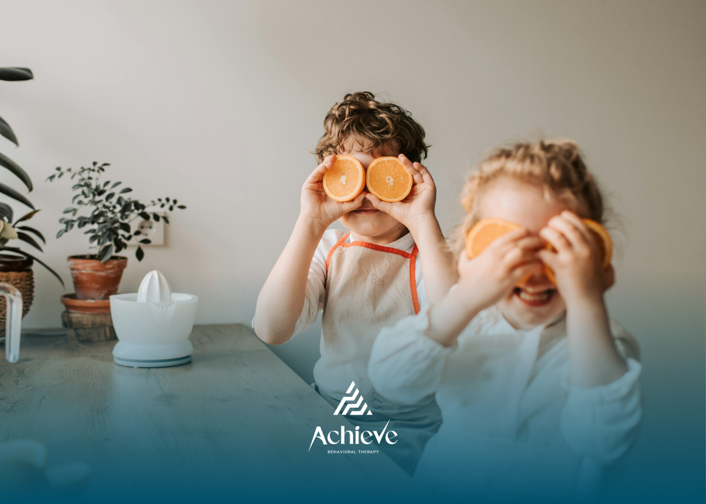 Two children peeking through orange slices in a bright indoor setting.