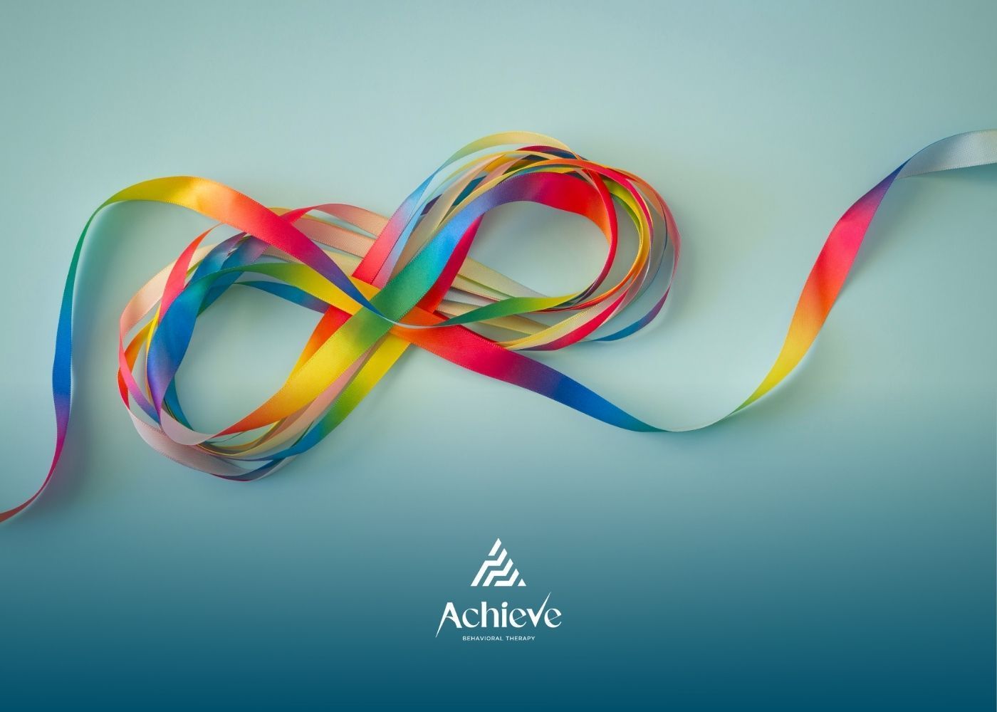 Colorful ribbon in an infinity symbol on a blue-green background. 