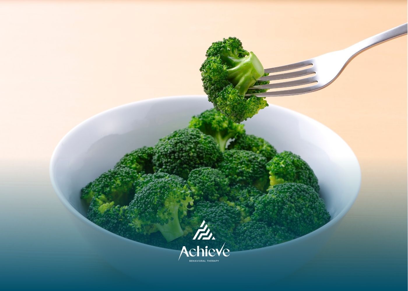 White bowl filled with broccoli; a fork holds a floret.