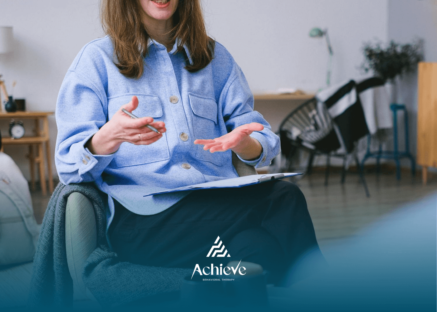 ABA Therapist gesturing while speaking during a counseling session and discussing the next session.