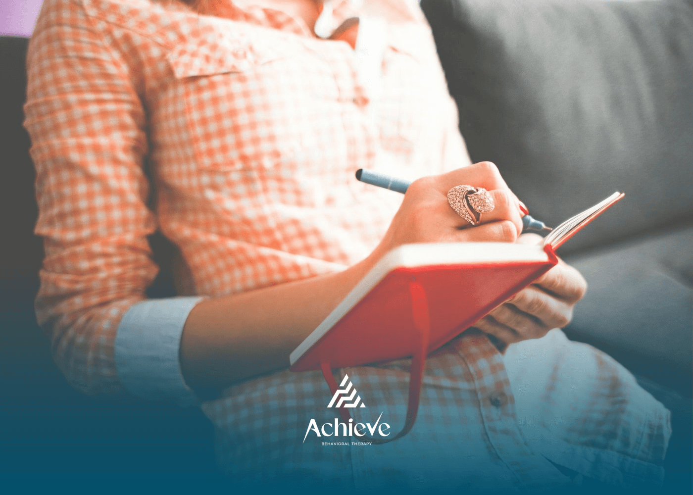 A person suspecting autism writing her symptoms in a notebook with a pen at home in North Carolina.