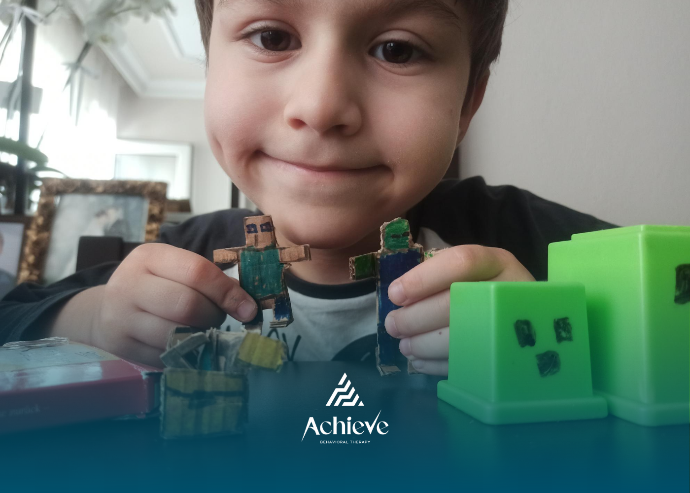 A boy holding Minecraft figures, smiling with excitement.