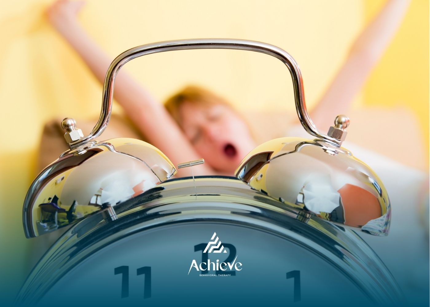 A close-up of a metal alarm clock in the foreground, with a person stretching and yawning in the blurred background.