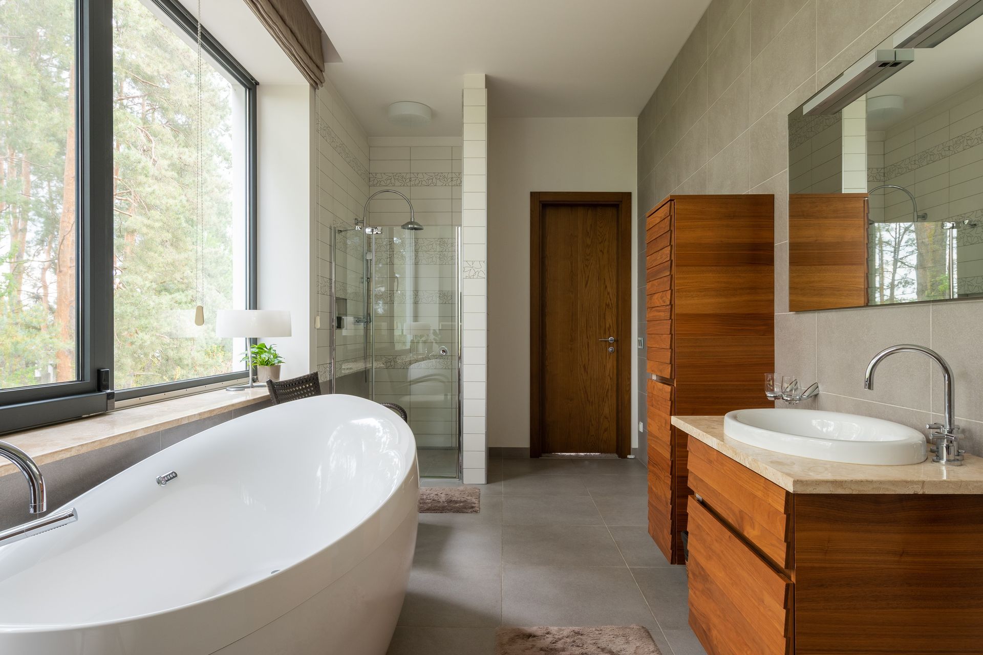 Freestanding bath and walk-in shower in stylish, modern Bristol bathroom.