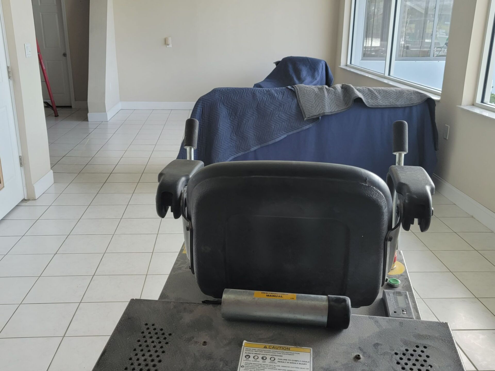 An empty room with a chair in the middle of it