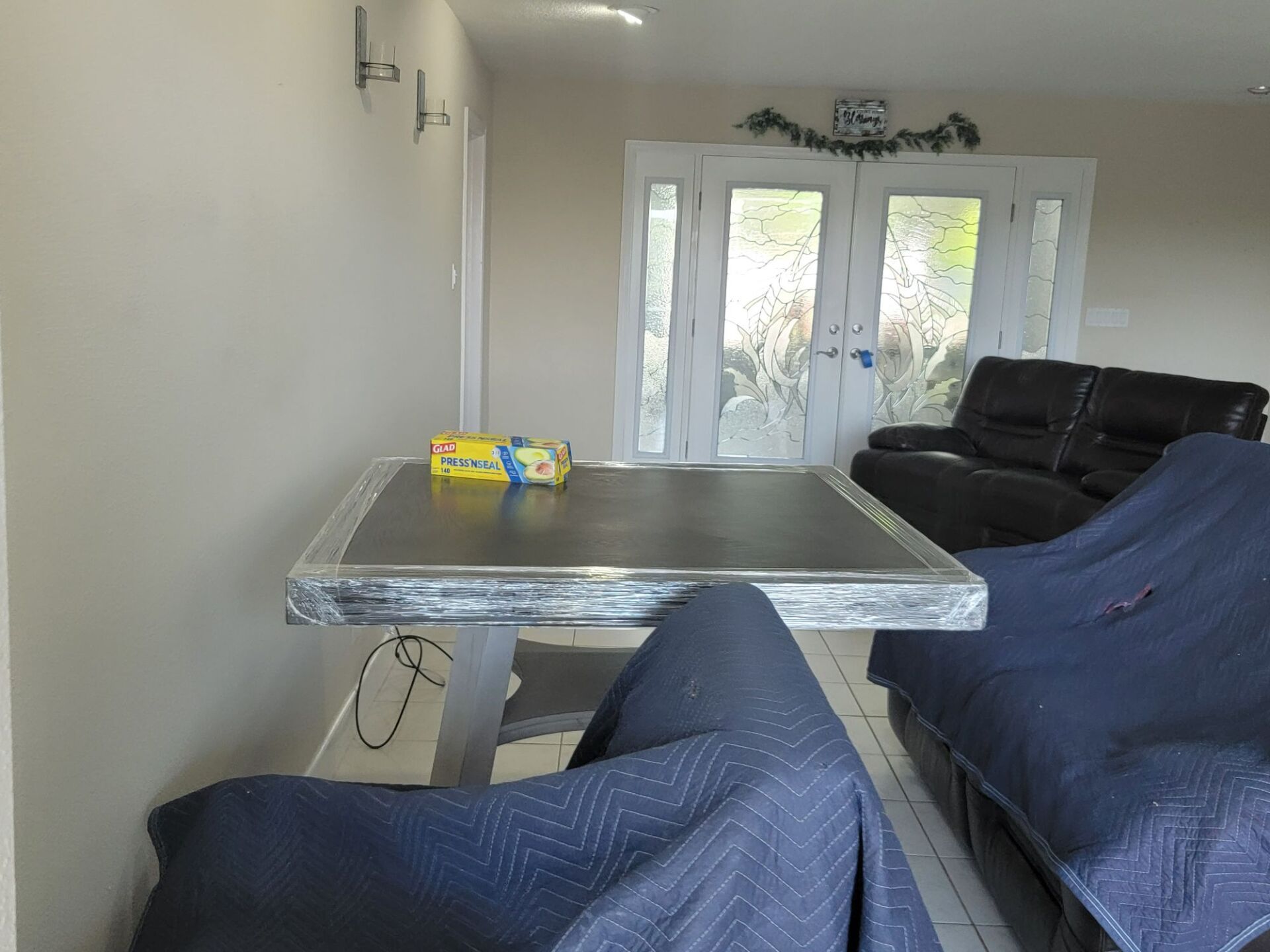 A living room with a table and chairs and a couch