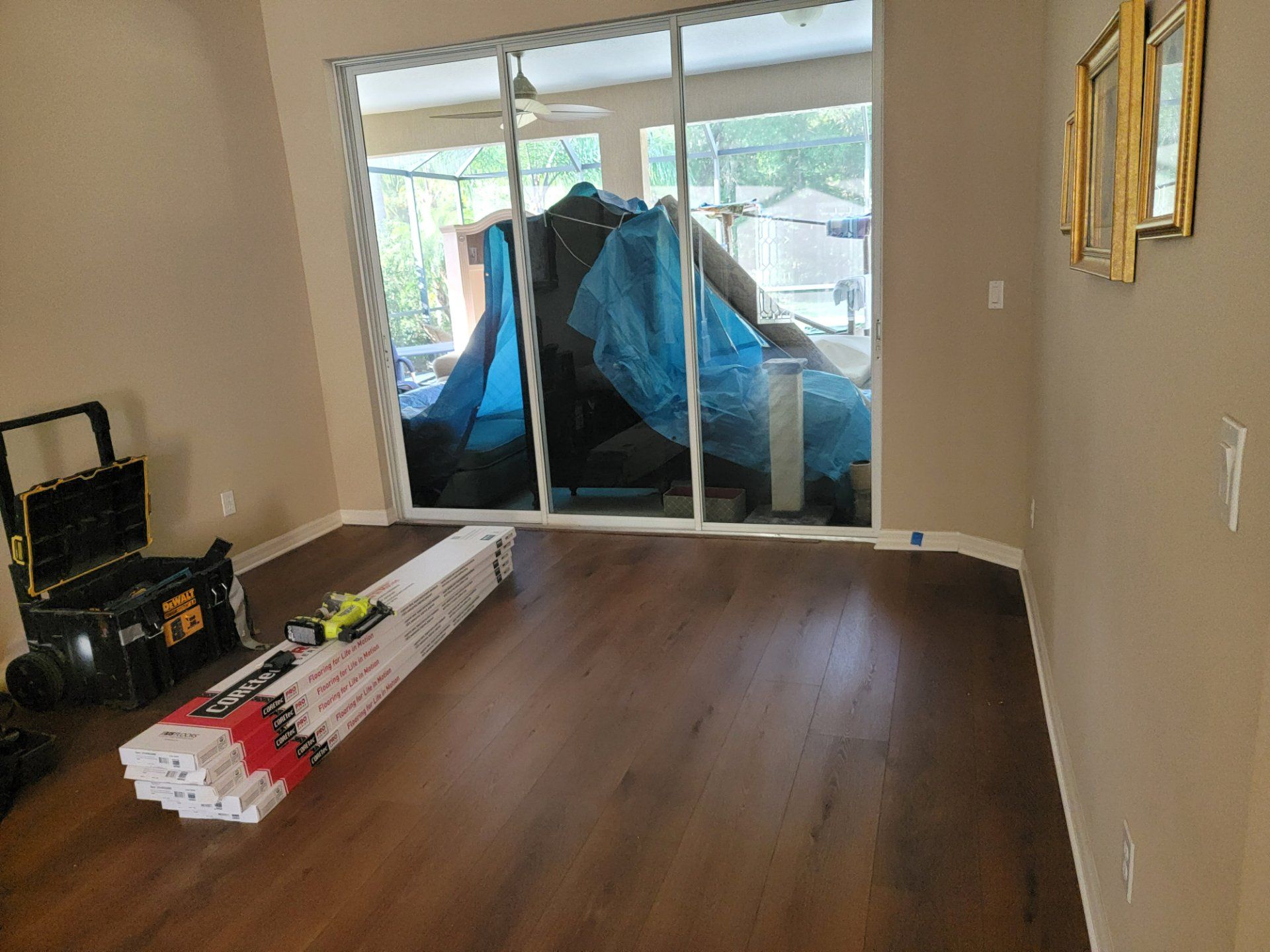 A living room with hardwood floors and a sliding glass door.