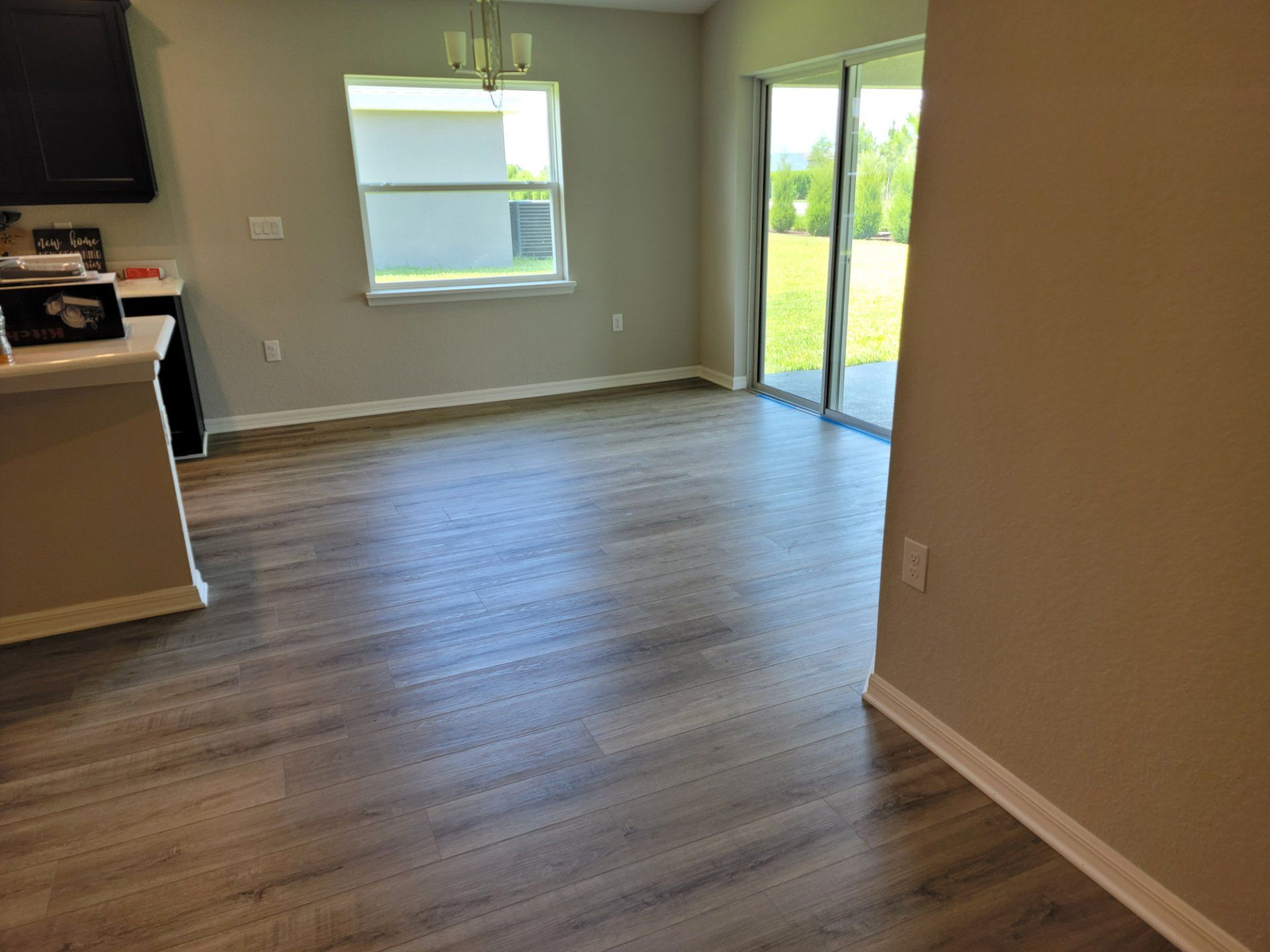 A living room with hardwood floors and a sliding glass door.