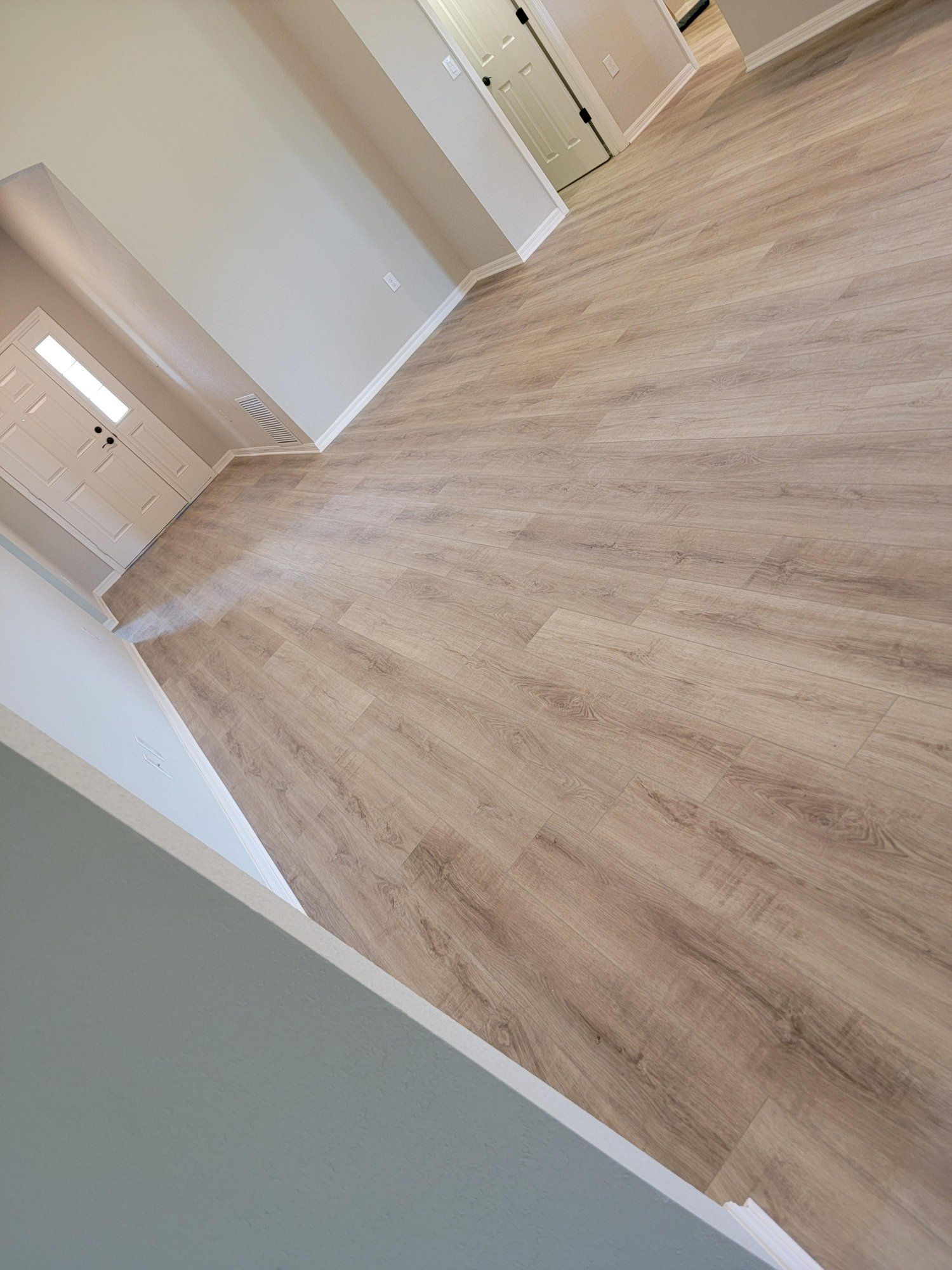 A living room with a wooden floor and white walls.