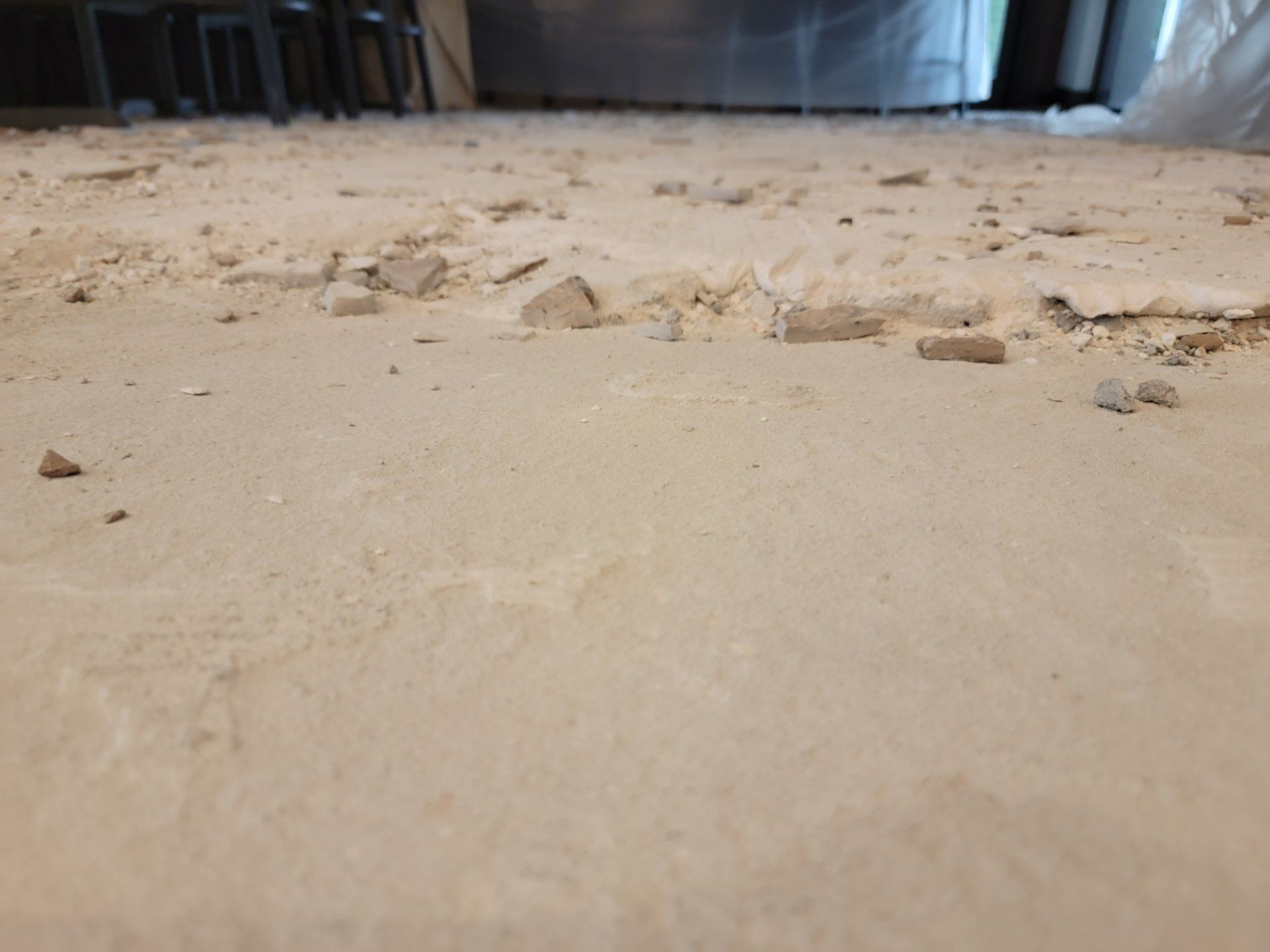 A dirty floor with a lot of bricks on it