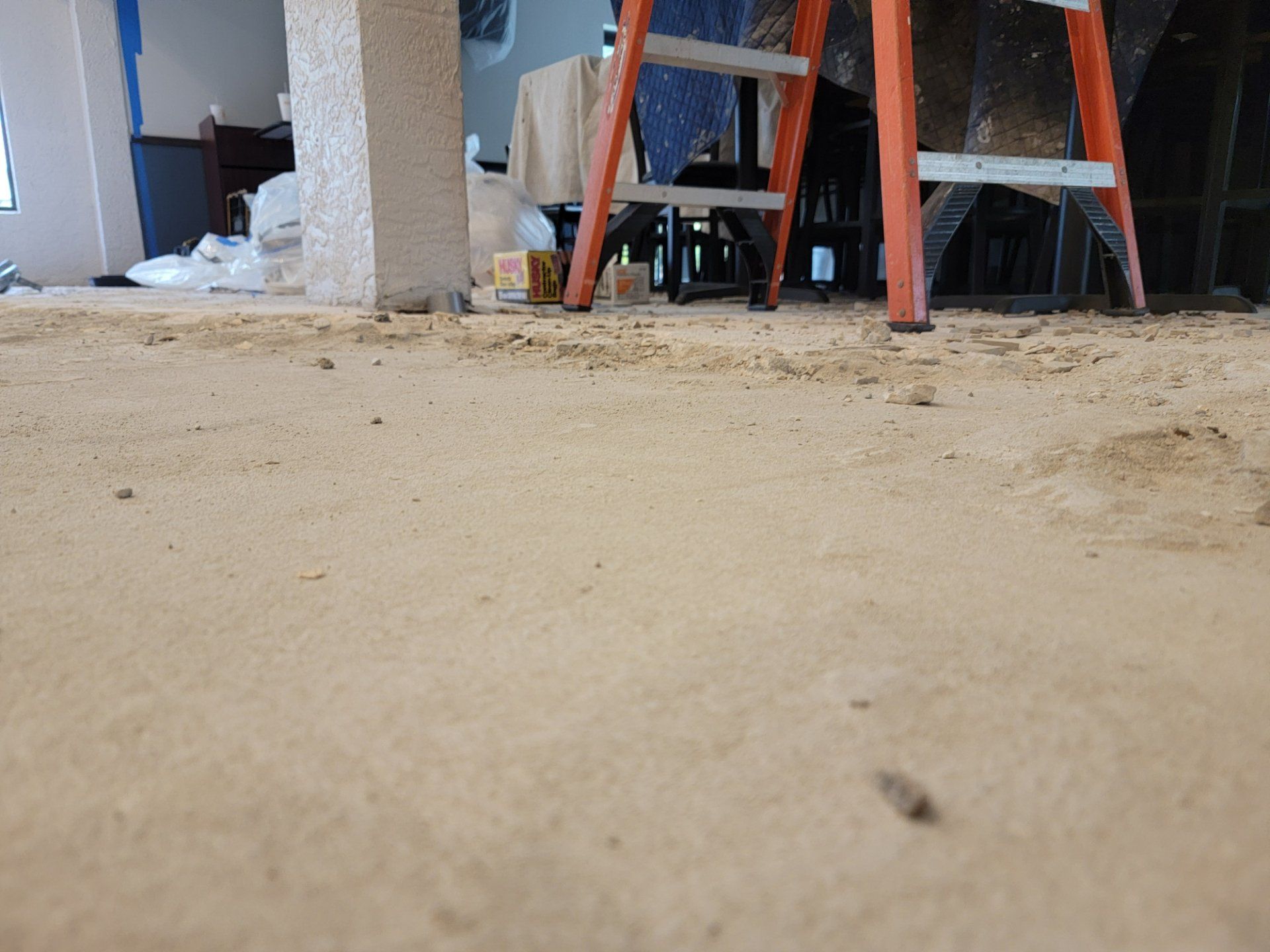 A ladder is sitting on the floor of a room.