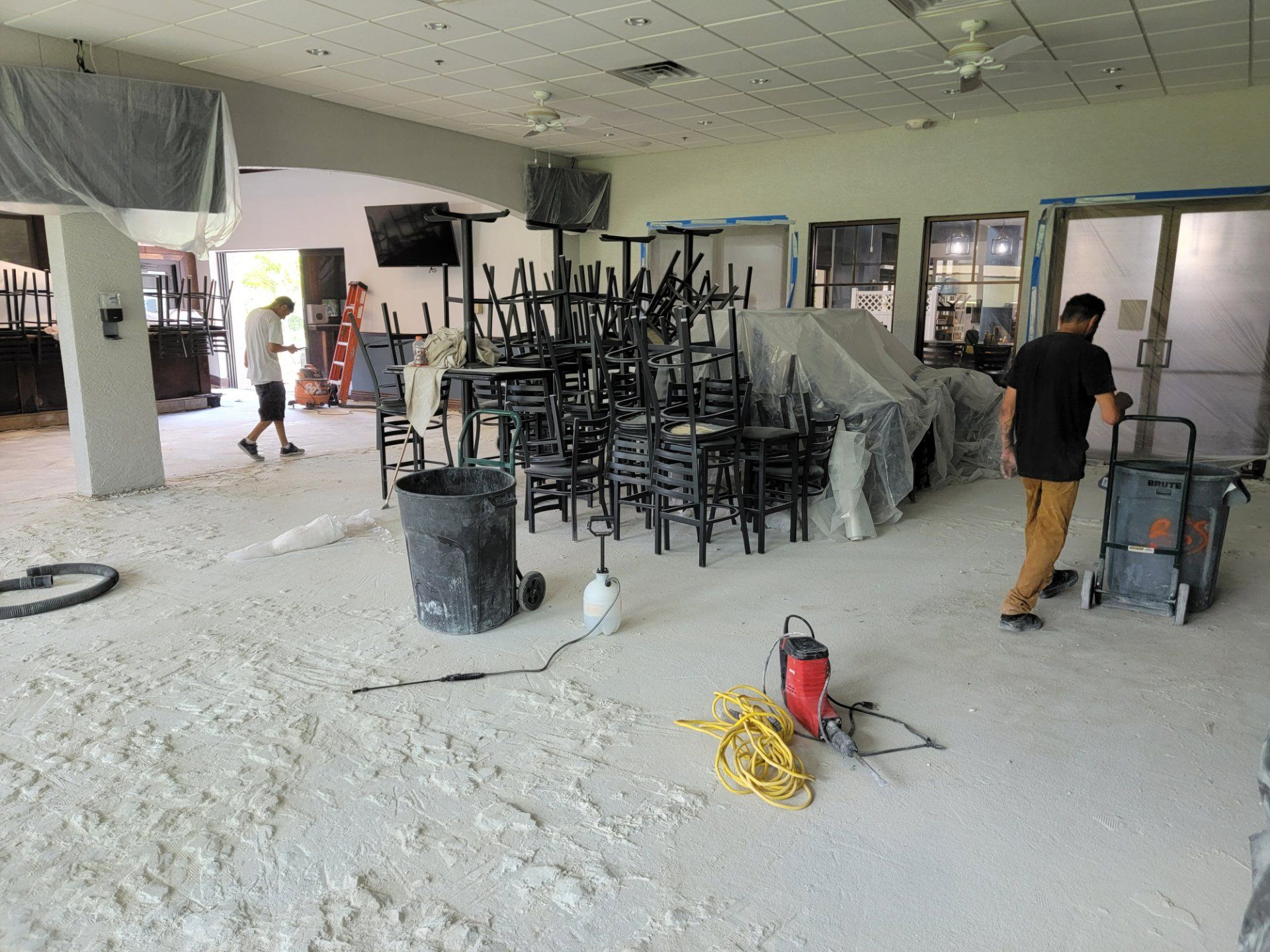 A room with a lot of chairs stacked on top of each other