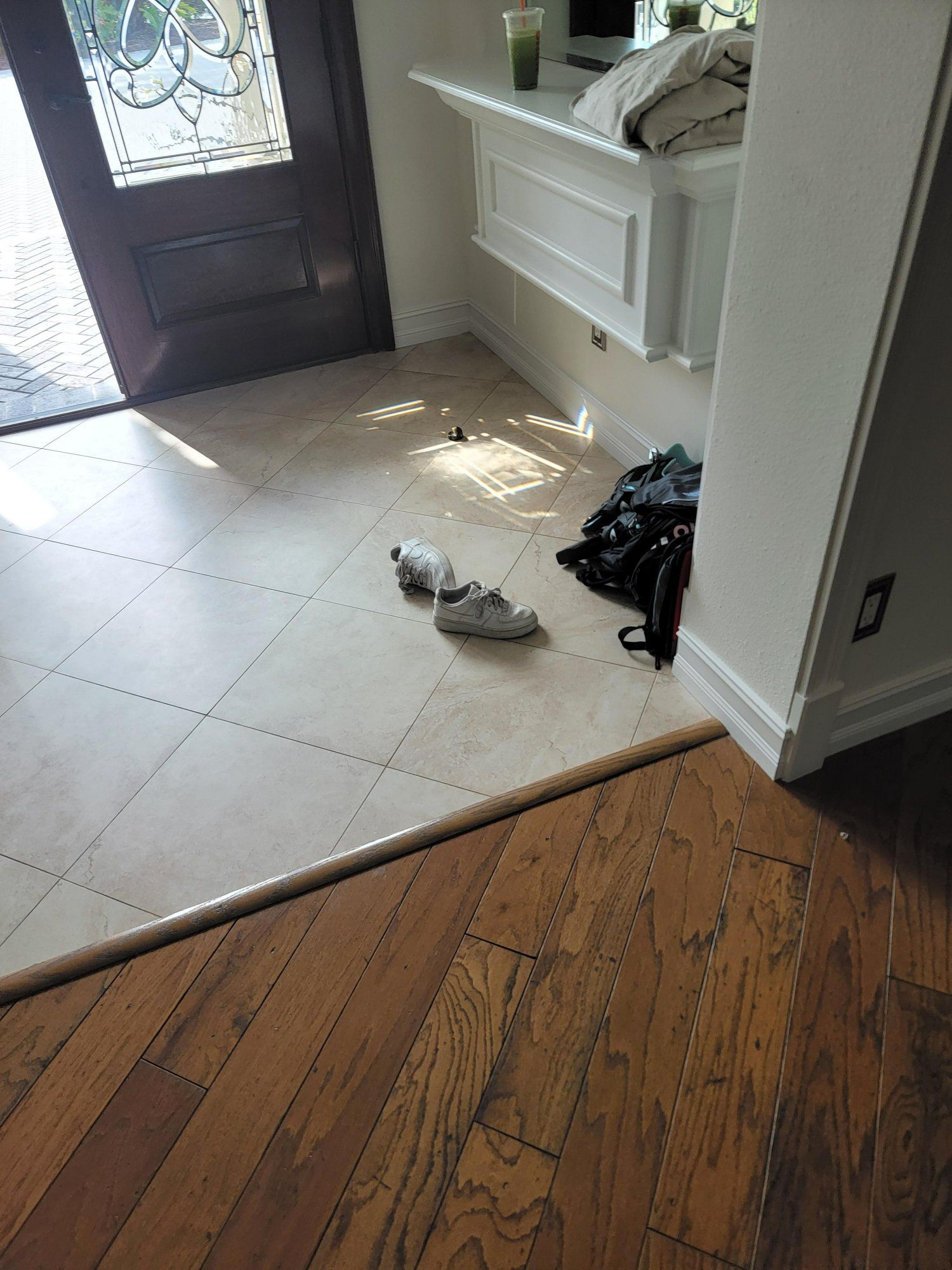 A pair of shoes are laying on the floor in a hallway.