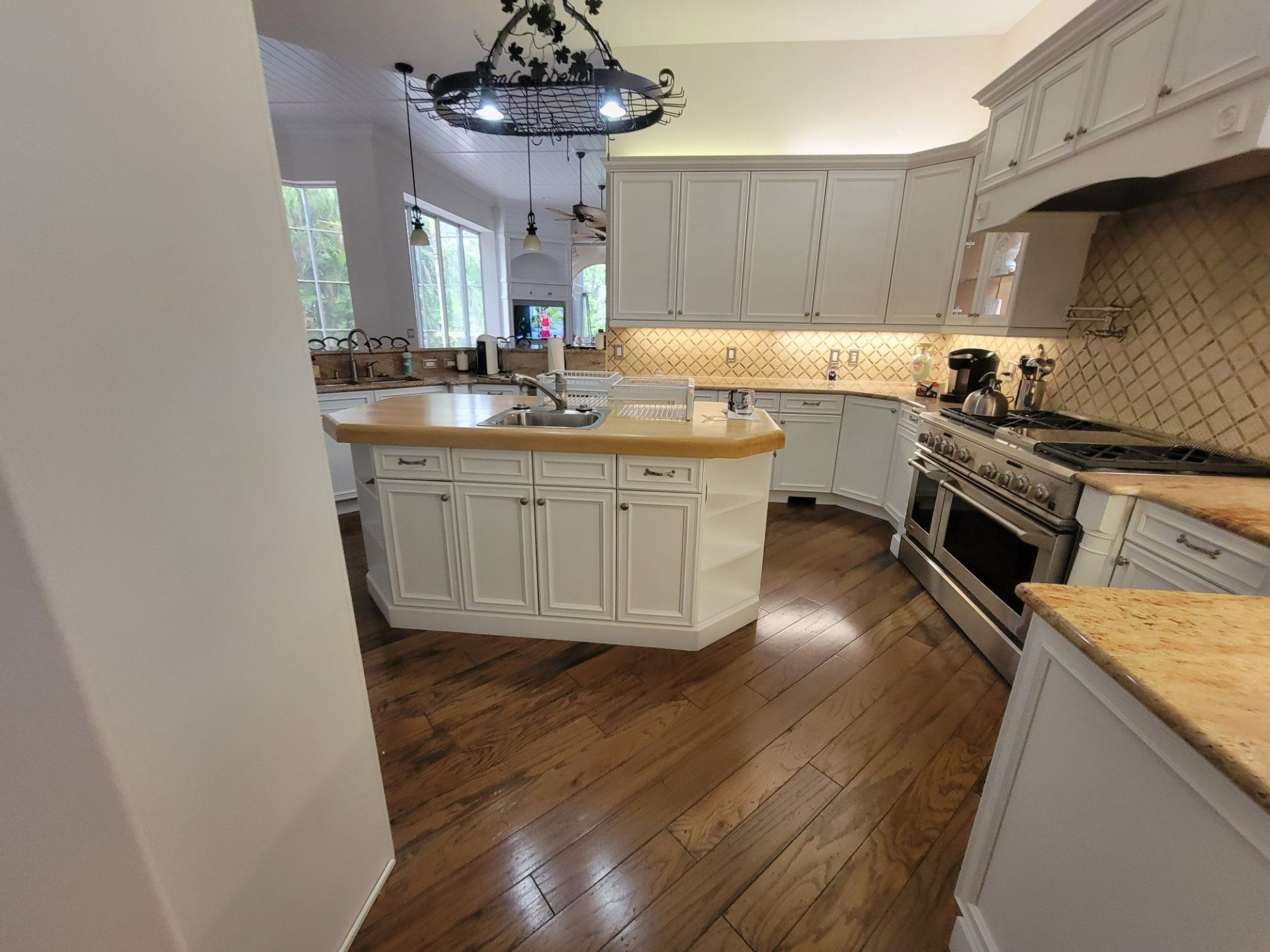 A kitchen with white cabinets and stainless steel appliances