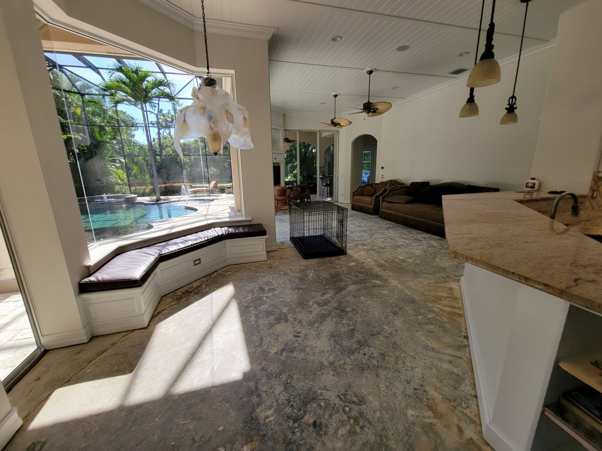 A living room with a couch and a cage in it.