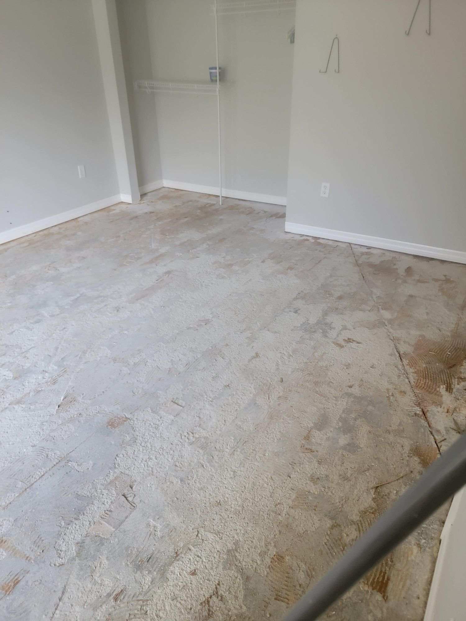 A room with a concrete floor and white walls.