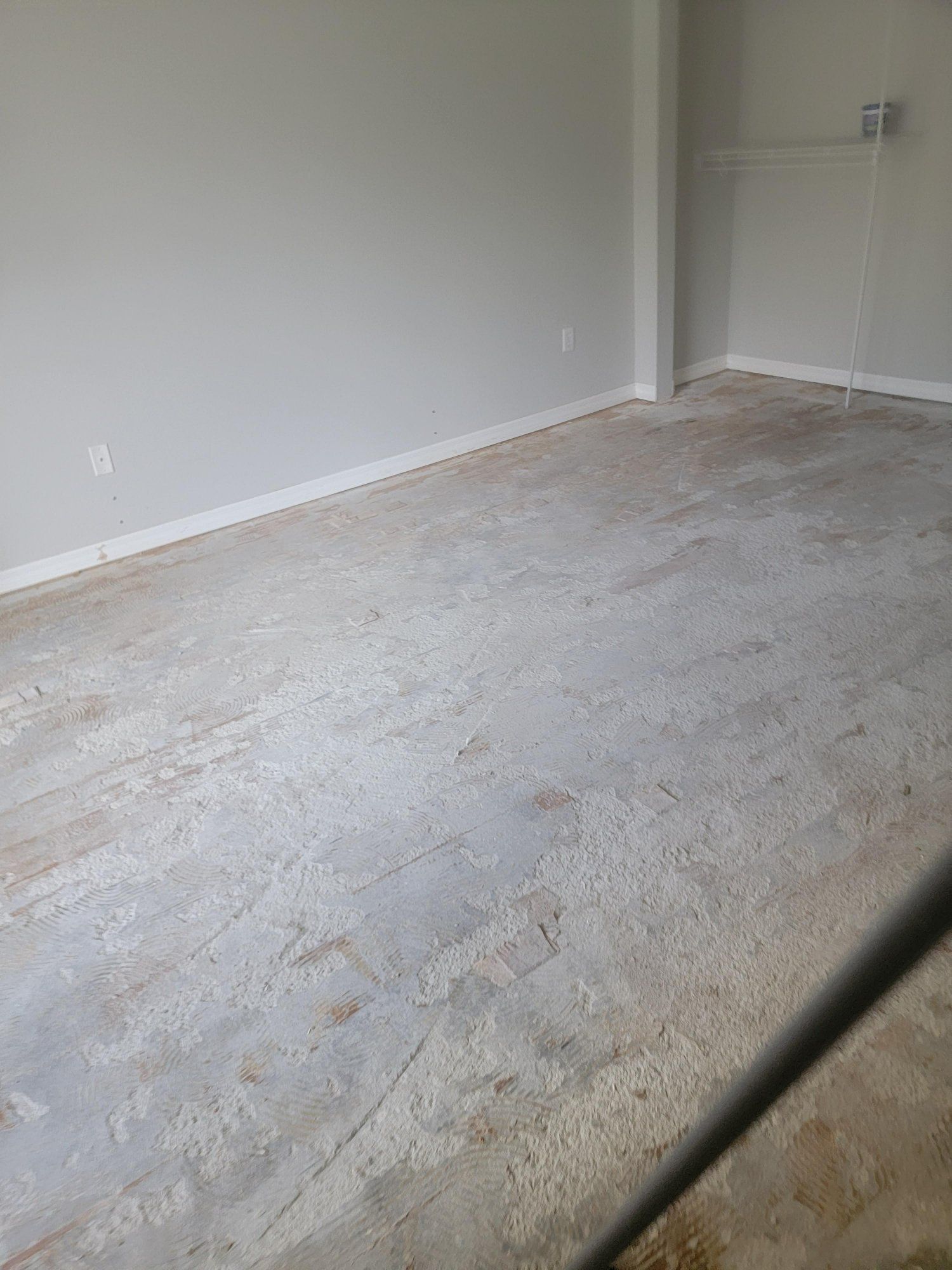 A room with a concrete floor and white walls.