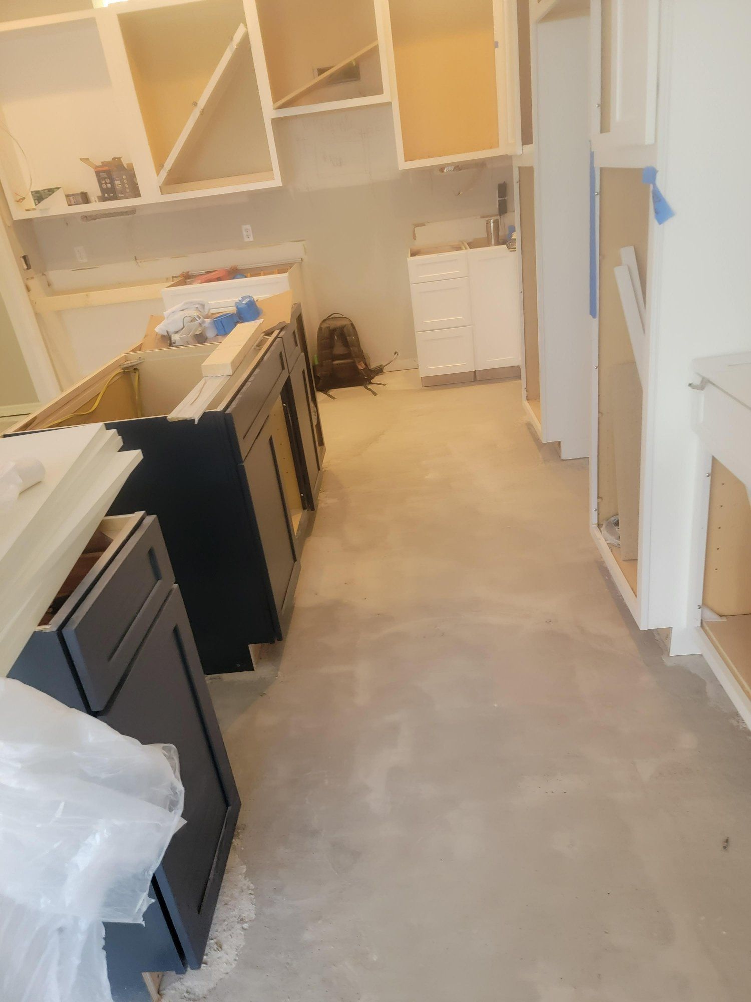 A kitchen is being remodeled and the cabinets are being installed.