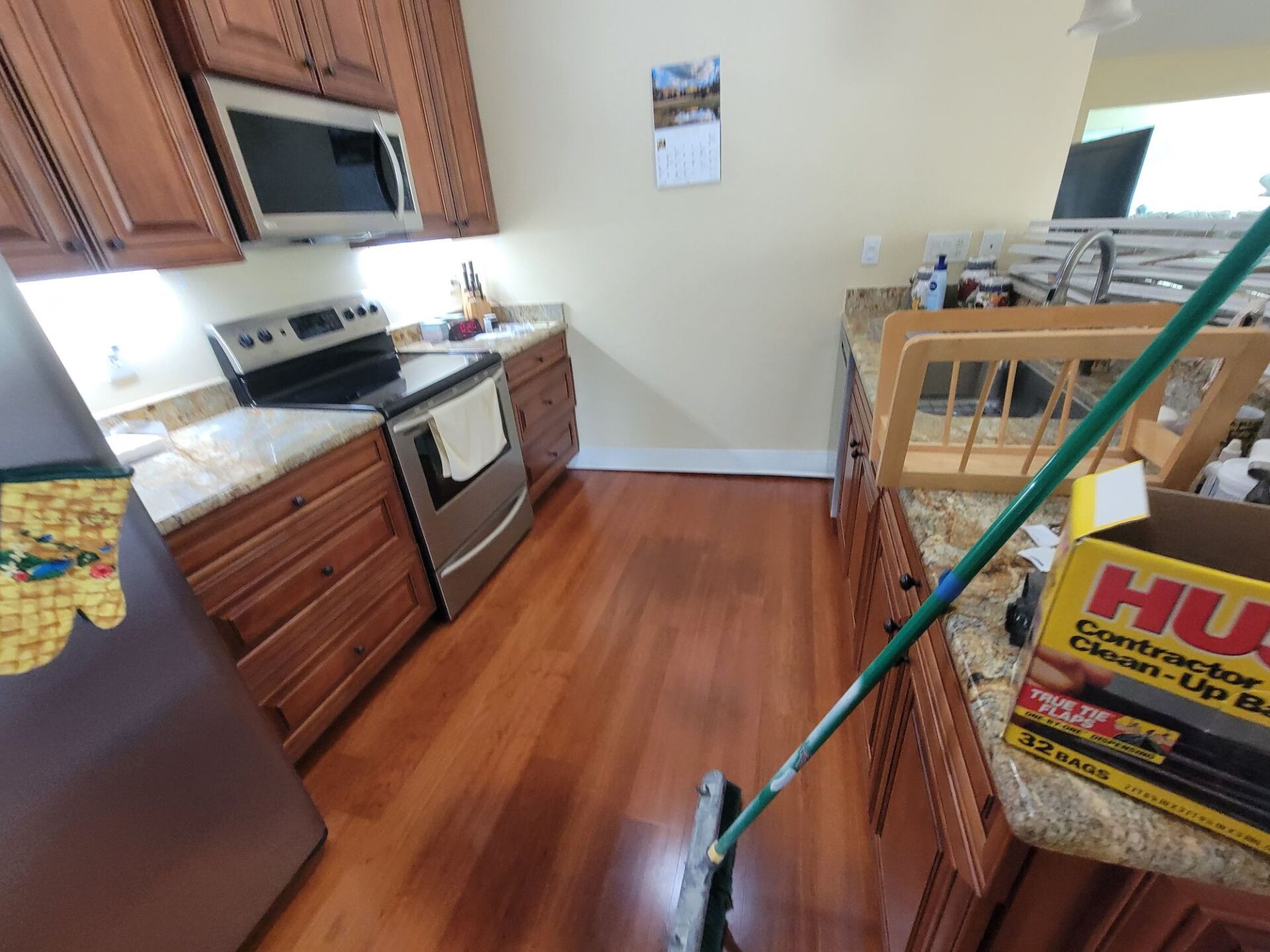 A kitchen with hardwood floors and a box of husqvarna cleaner