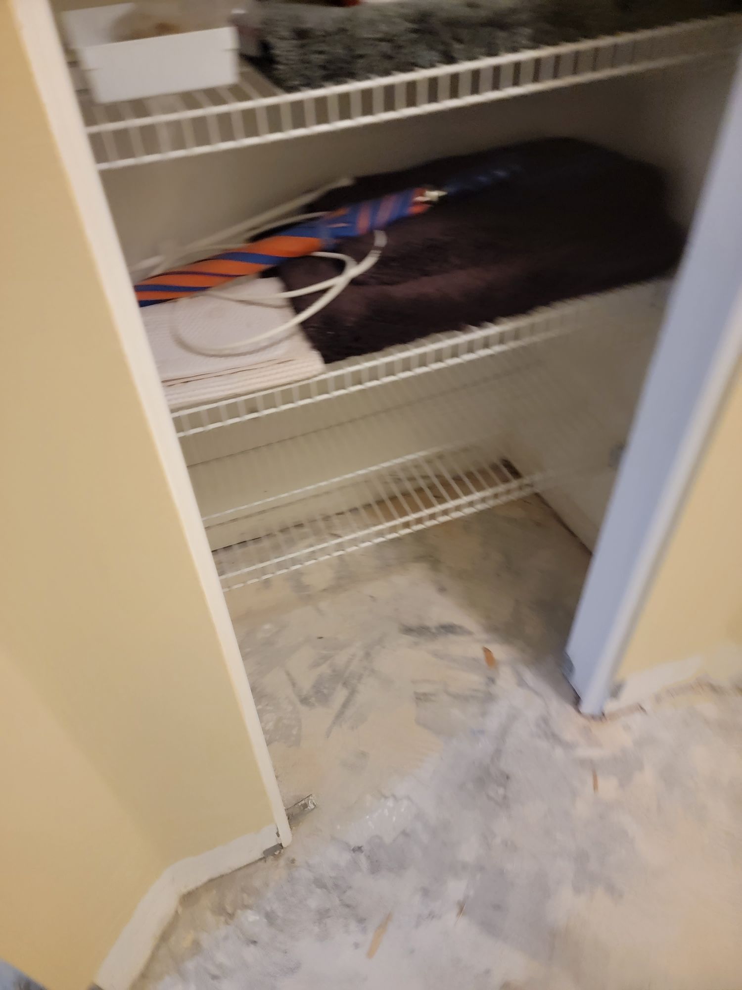 A closet with a bunch of clothes on the shelves