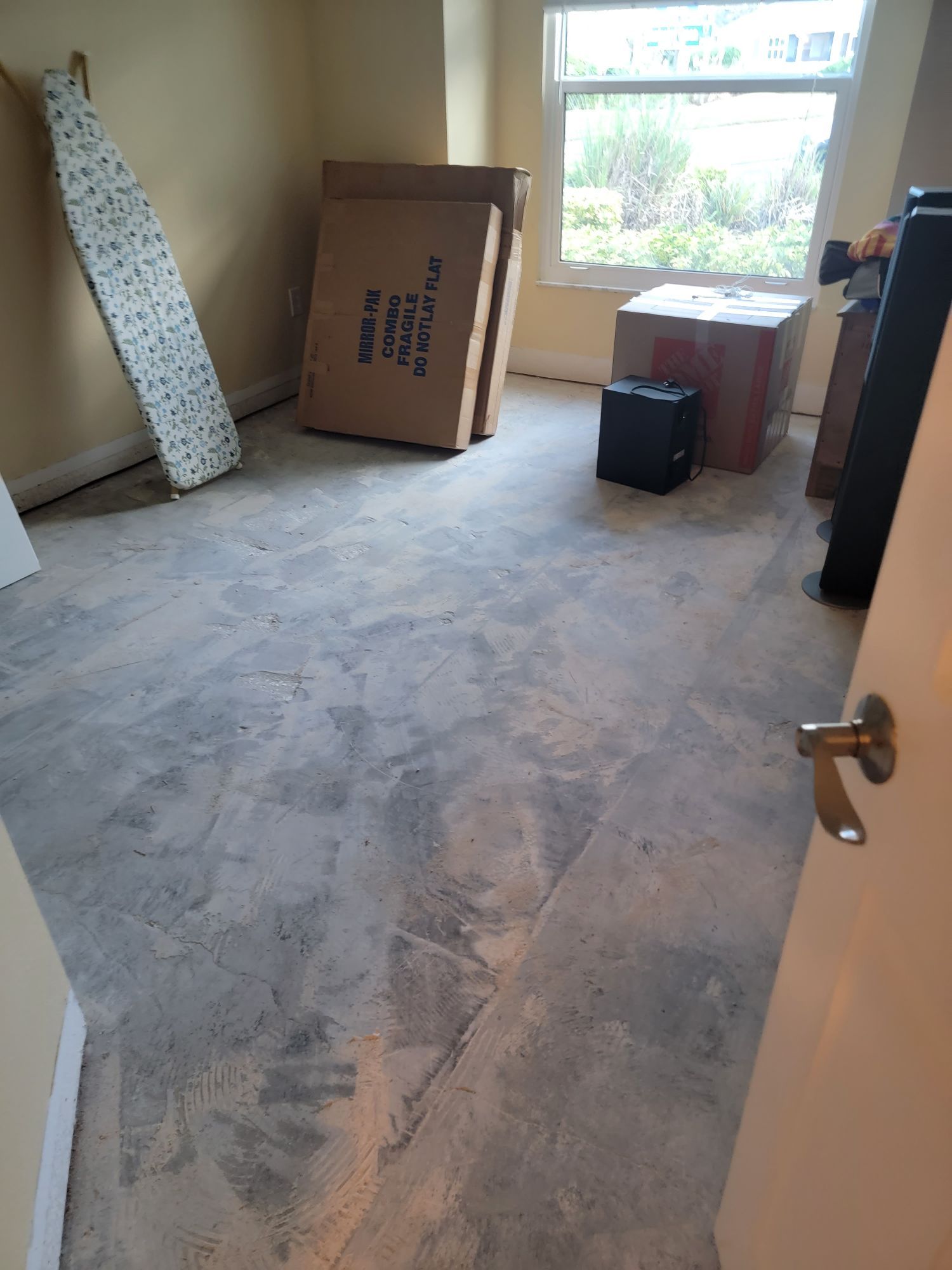 A room with boxes on the floor and a window