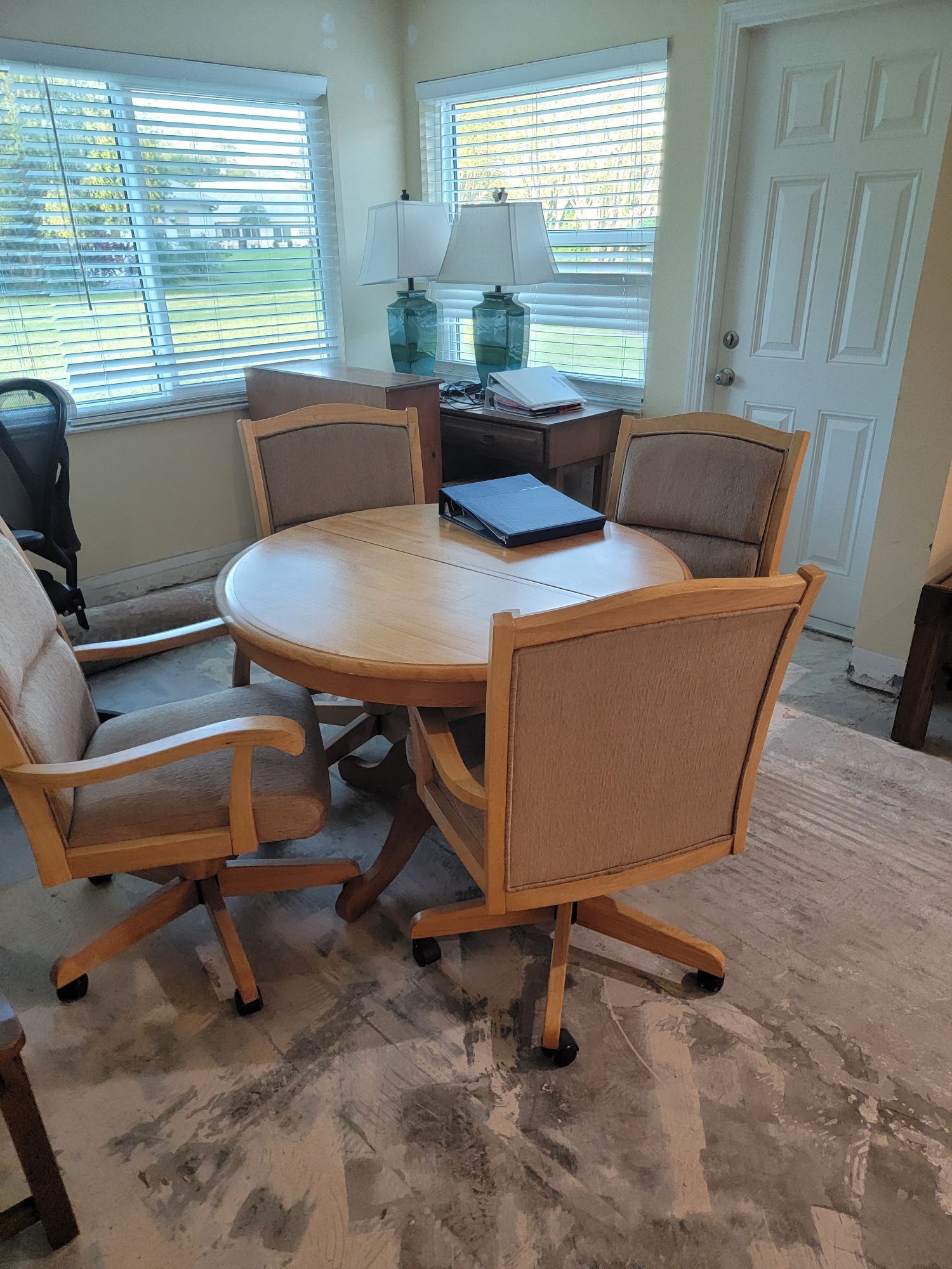 There is a table and chairs in the room.