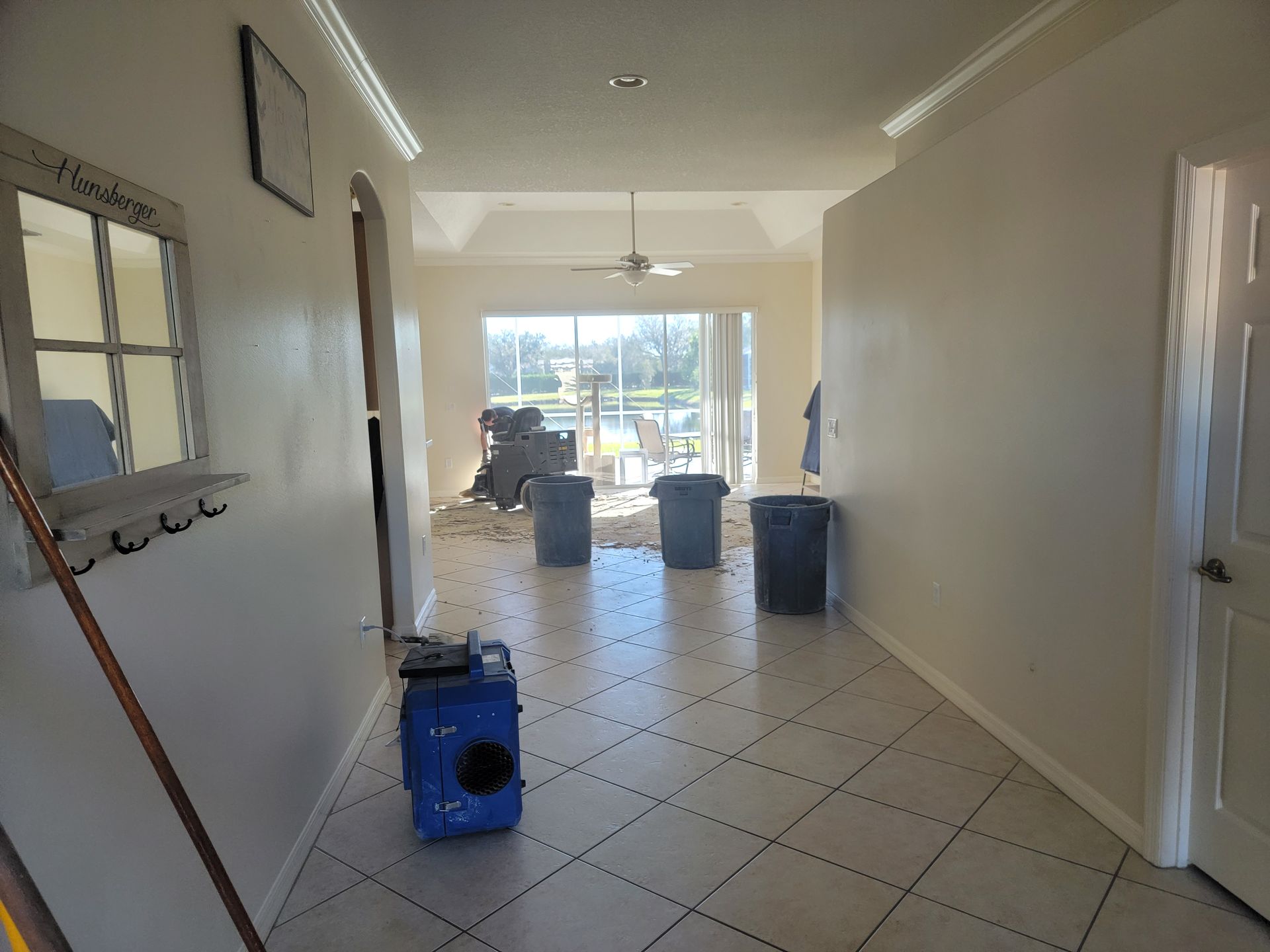 A hallway with a blue vacuum sitting on the floor