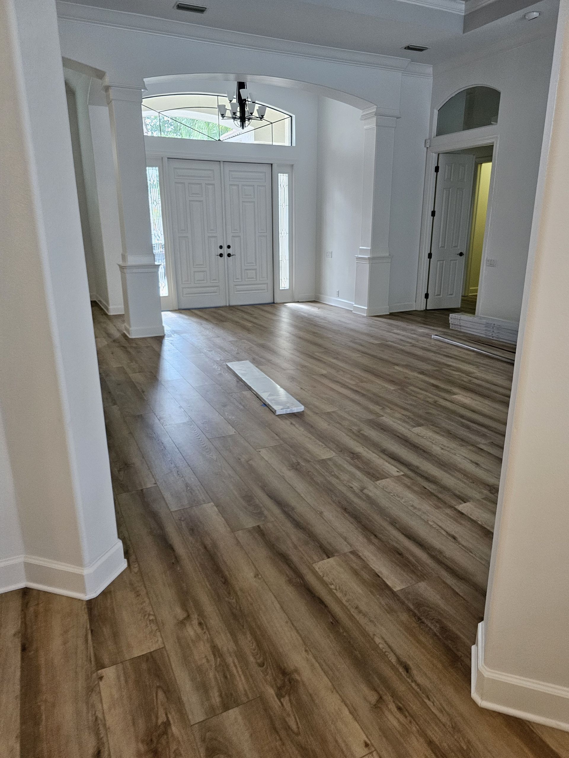 There is a piece of wood on the floor in the middle of the room.