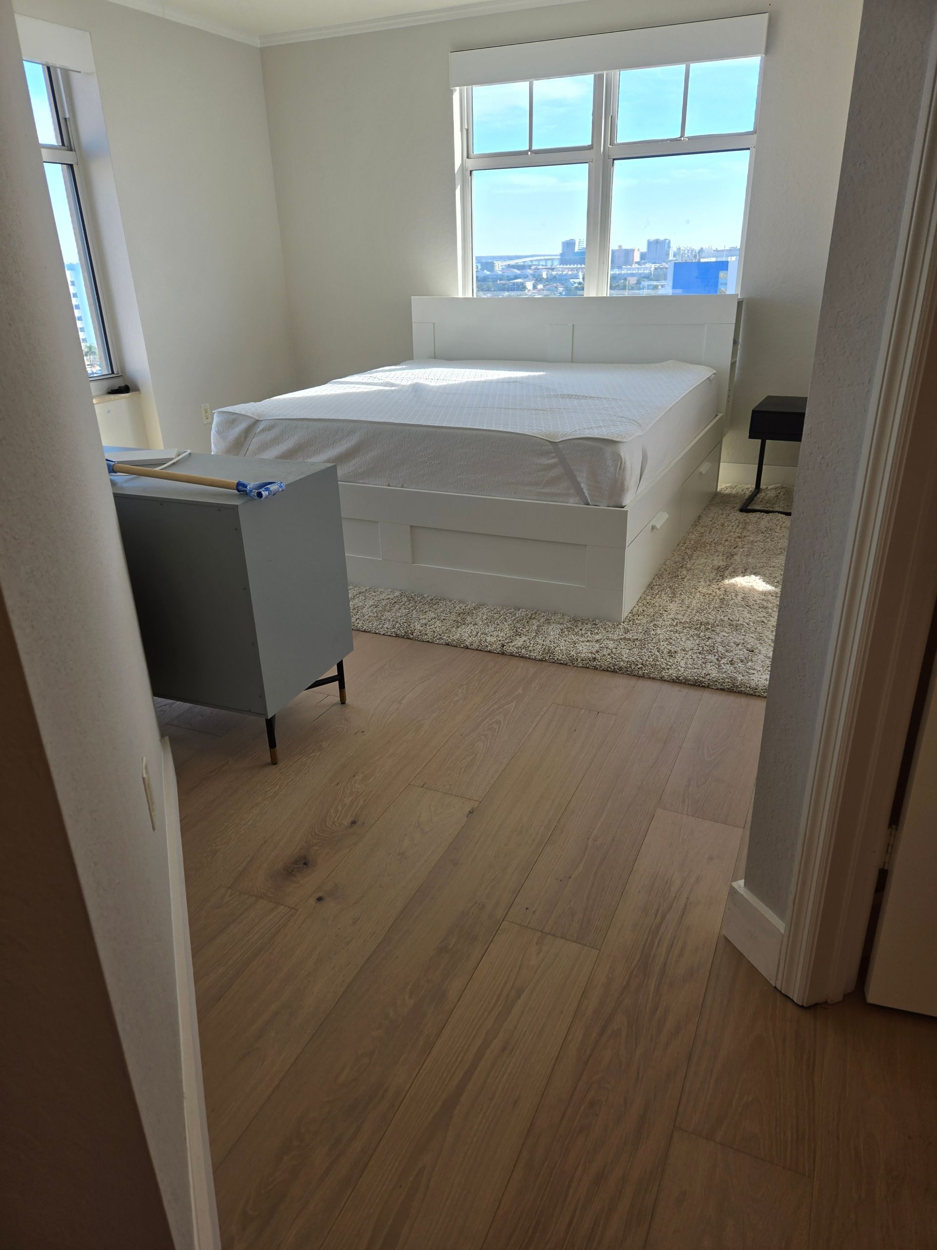 Spacious room with pool view, stone floors, built-in bench, dog crate, and hanging lights.