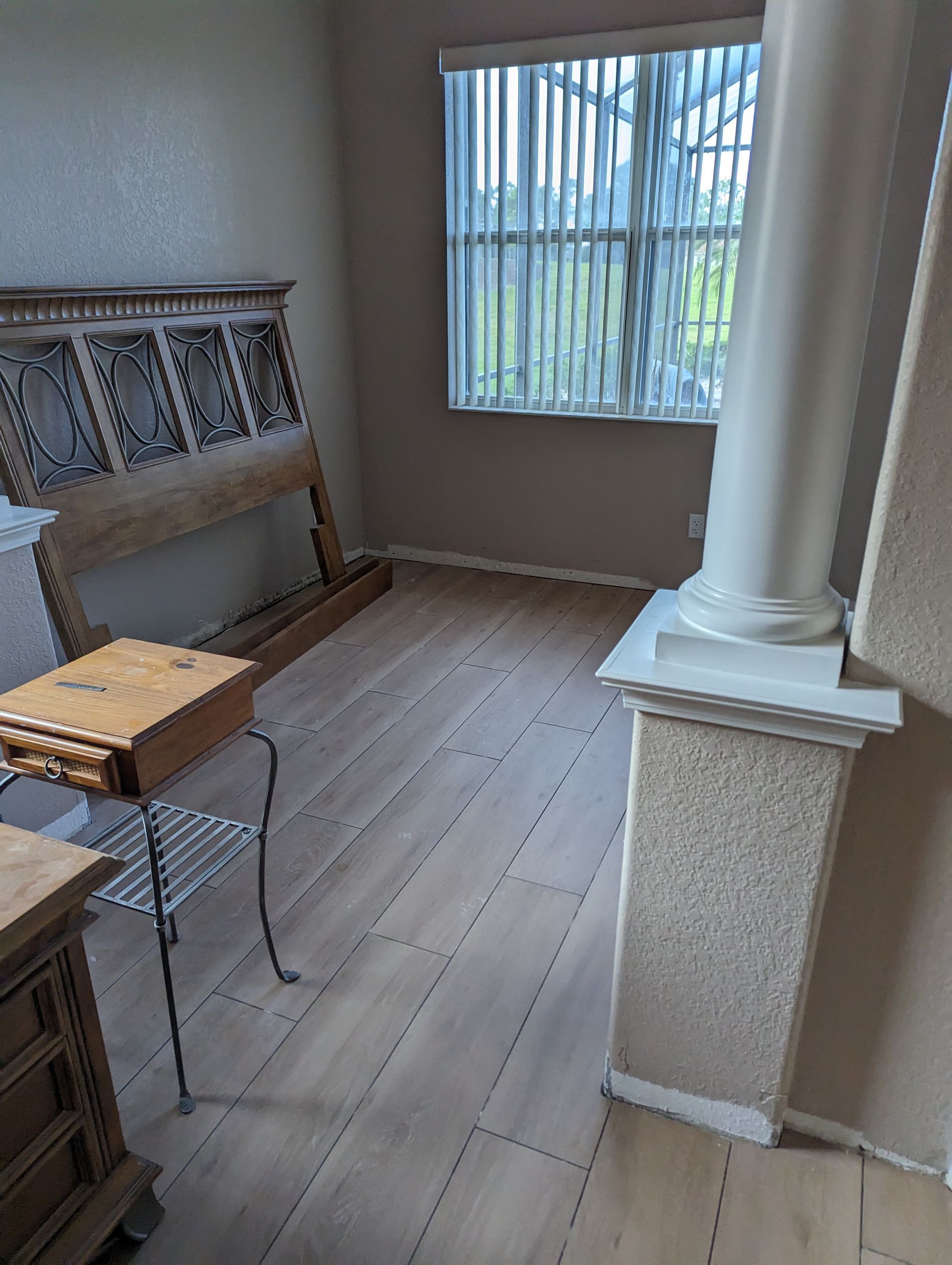 A living room with hardwood floors and a fireplace.