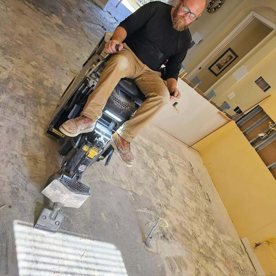 A man is sitting on a machine in a room