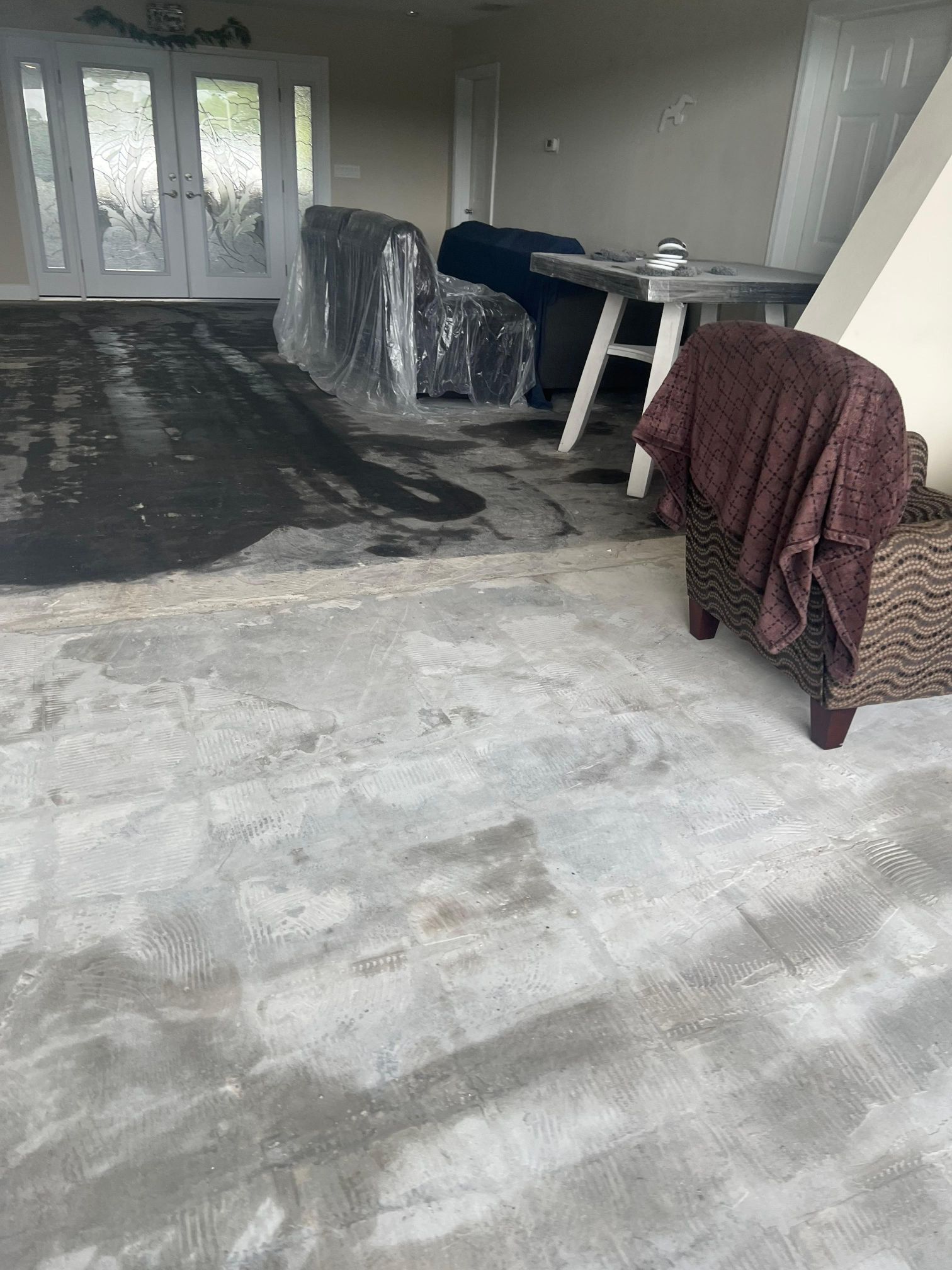 A living room with a chair and a table in it.