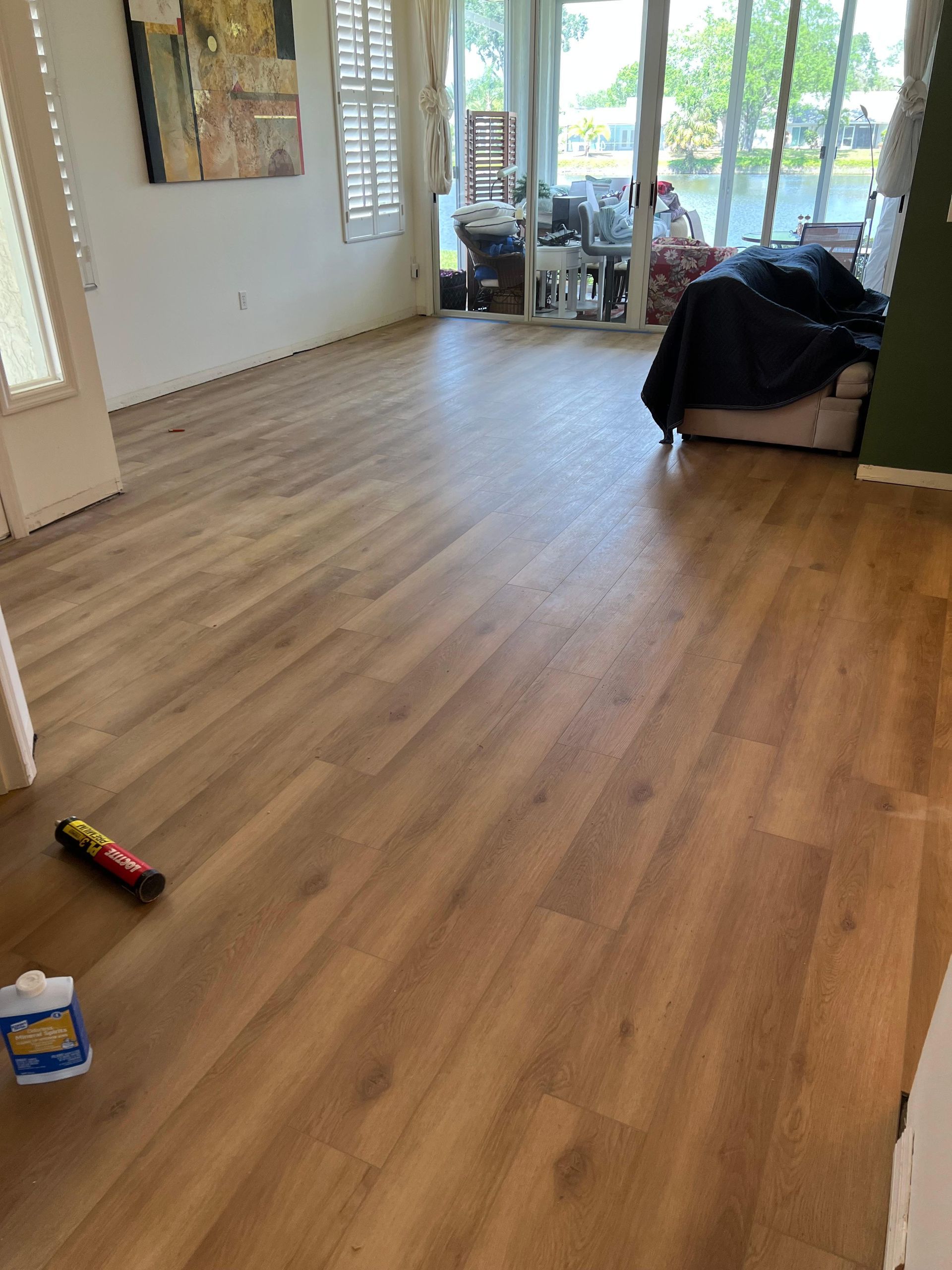 A living room with hardwood floors and sliding glass doors.