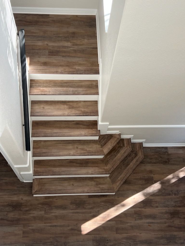 An aerial view of a wooden staircase in a house.