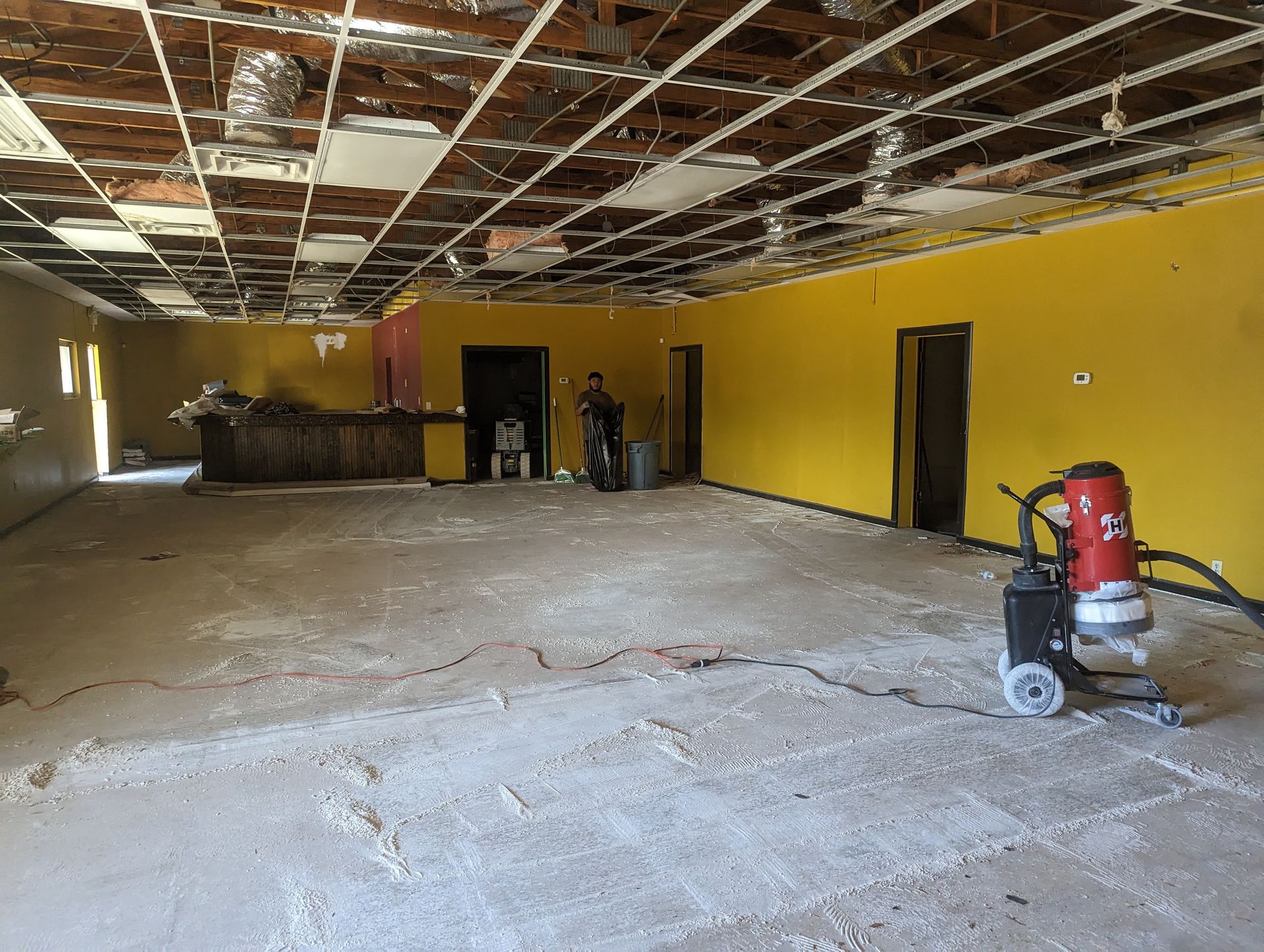 There is a vacuum cleaner in the middle of the room.