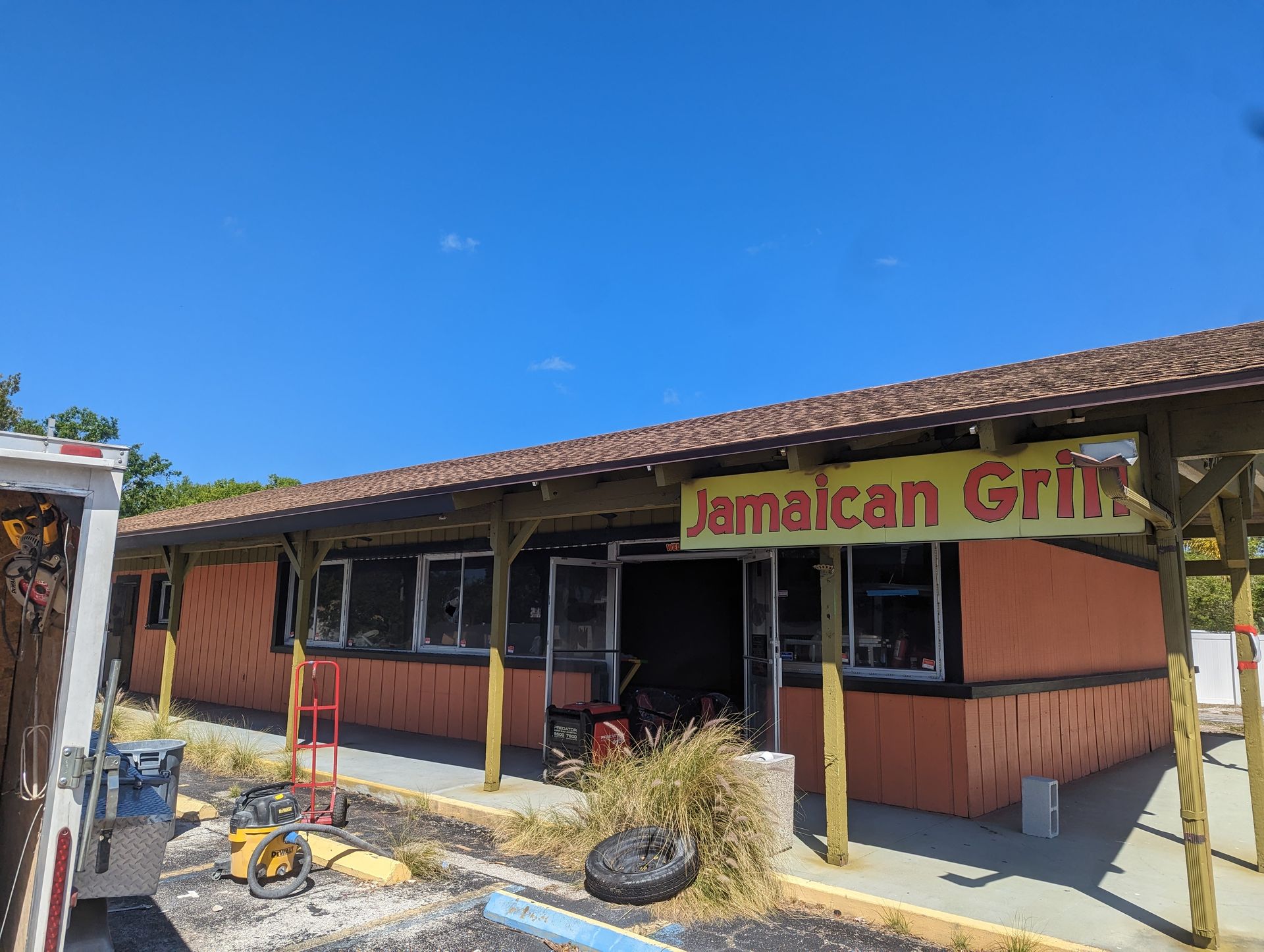 A building with a sign that says jamaican grill on it