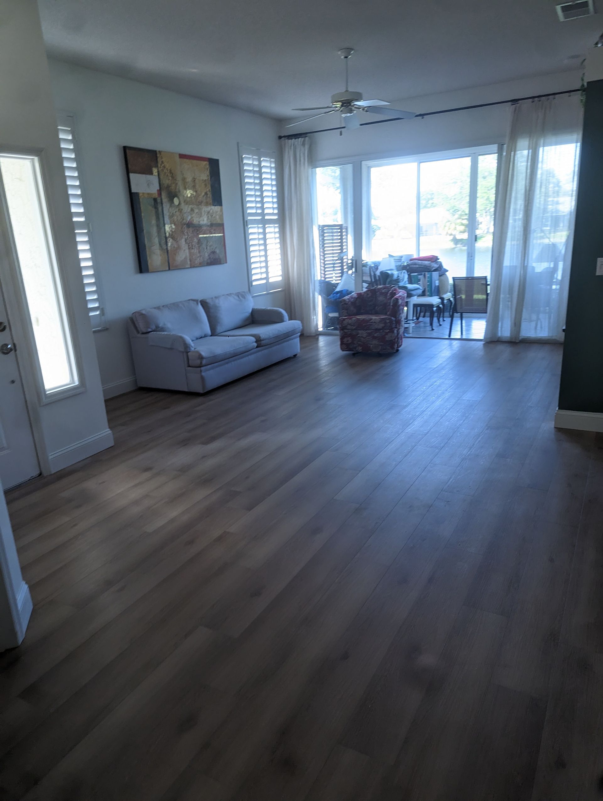 An empty living room with a couch and chairs