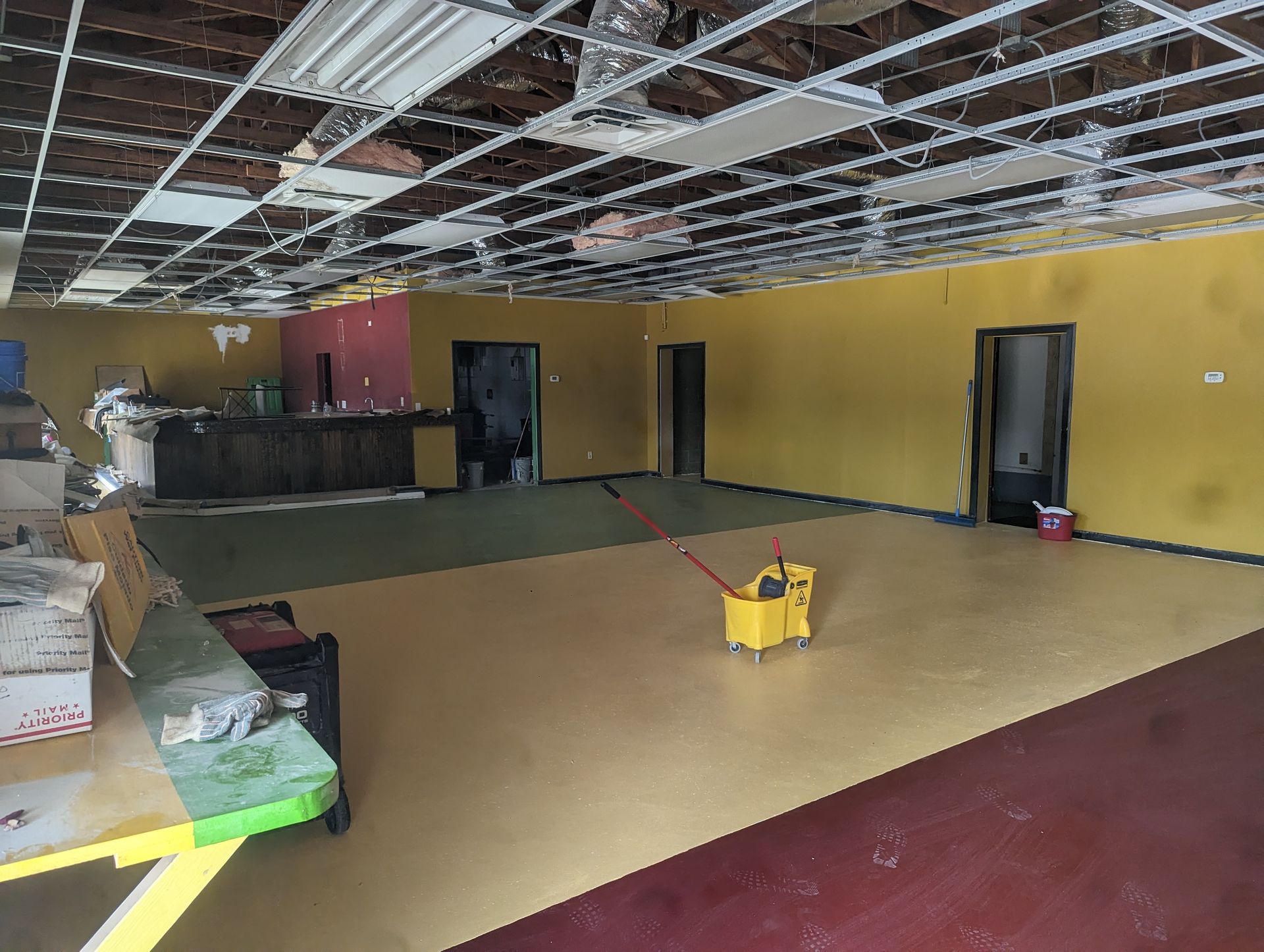 An empty room with a yellow mop on the floor.