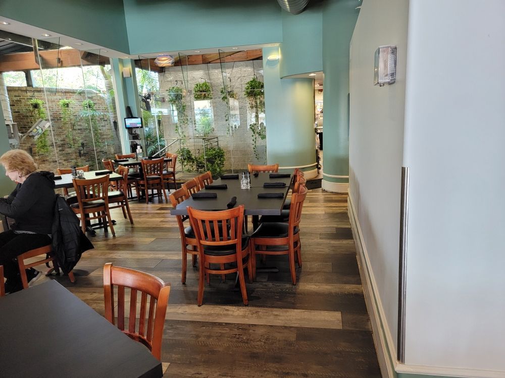 A woman is sitting at a table in a restaurant.