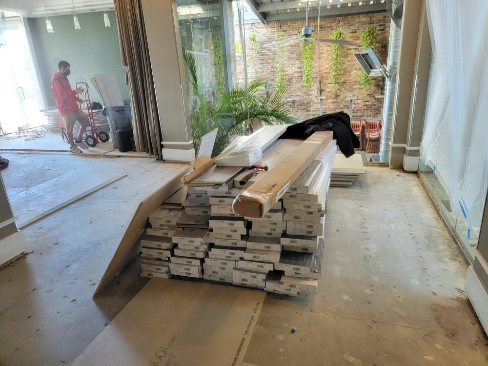 A pile of wood is sitting on the floor in a room.