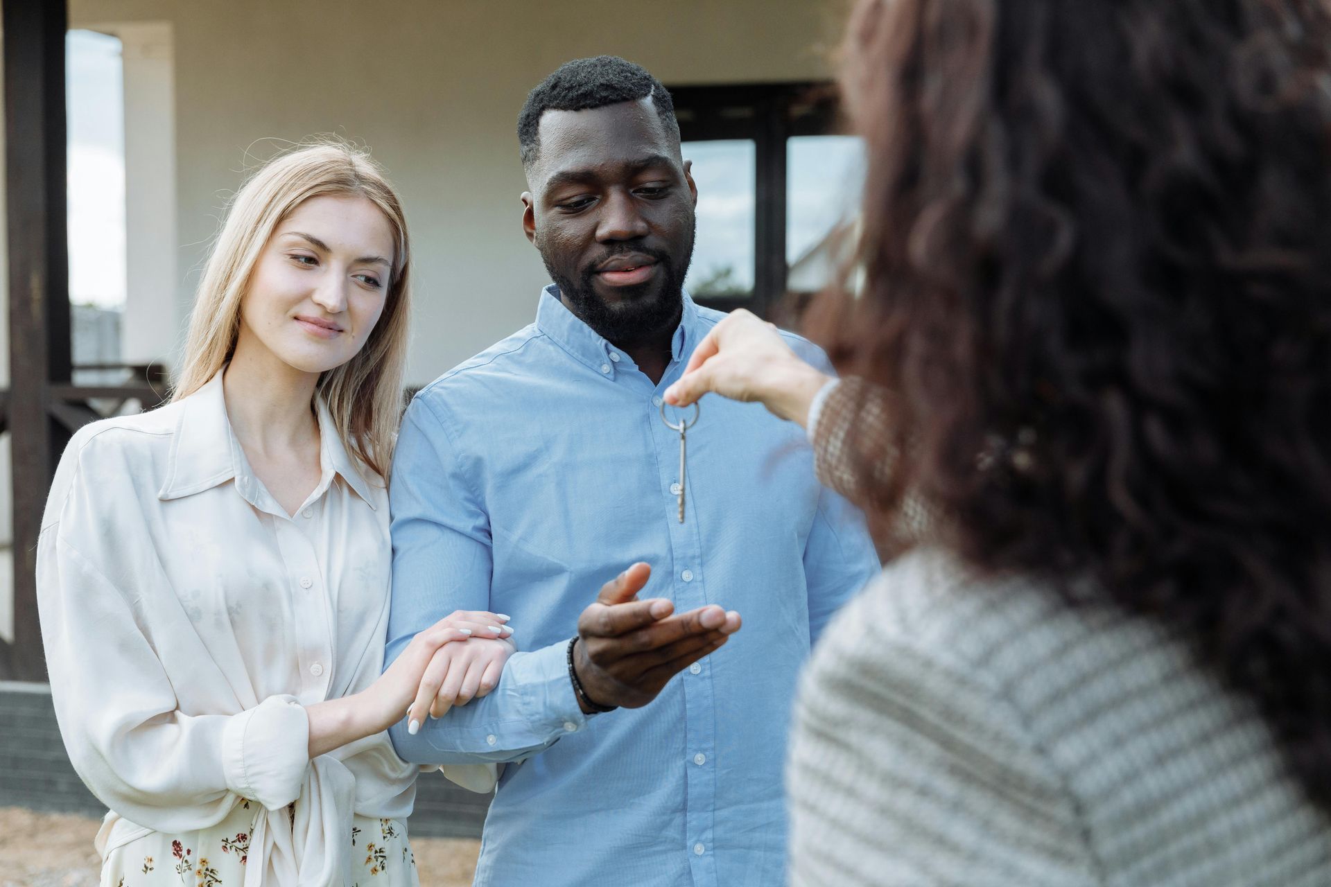 A man is giving a woman the keys to their new house.