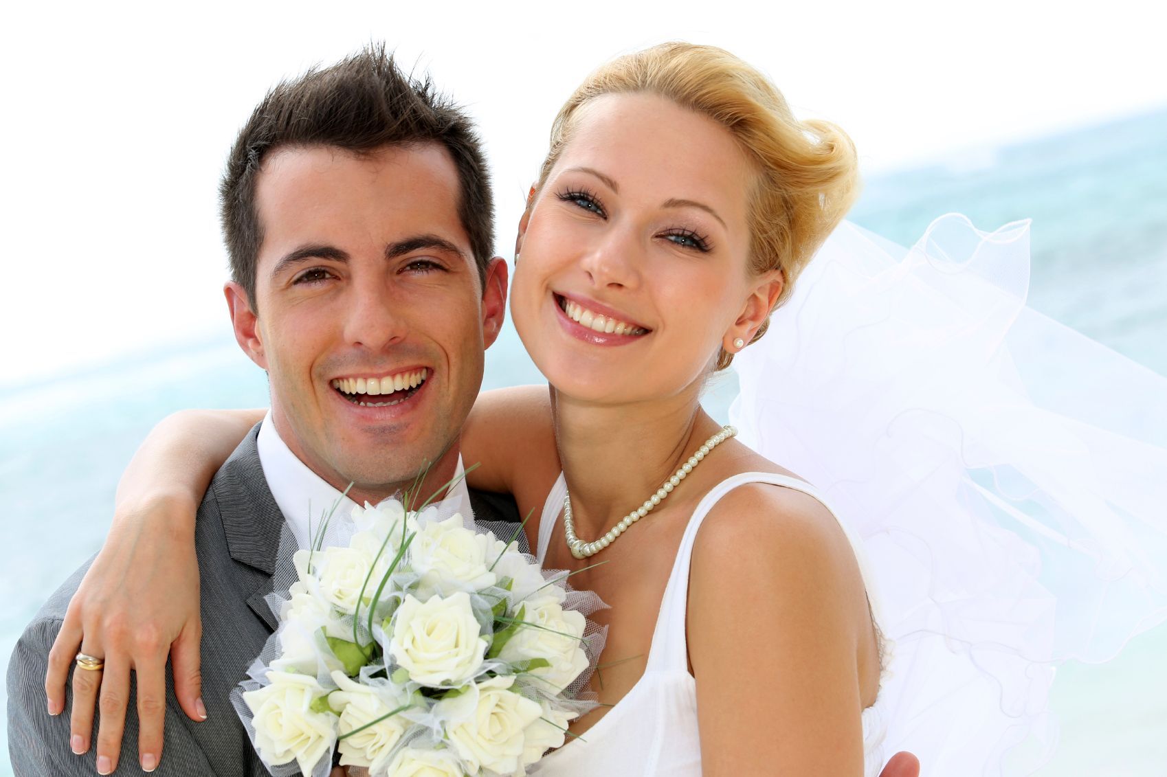 A bride and groom are posing for a picture on their wedding day.