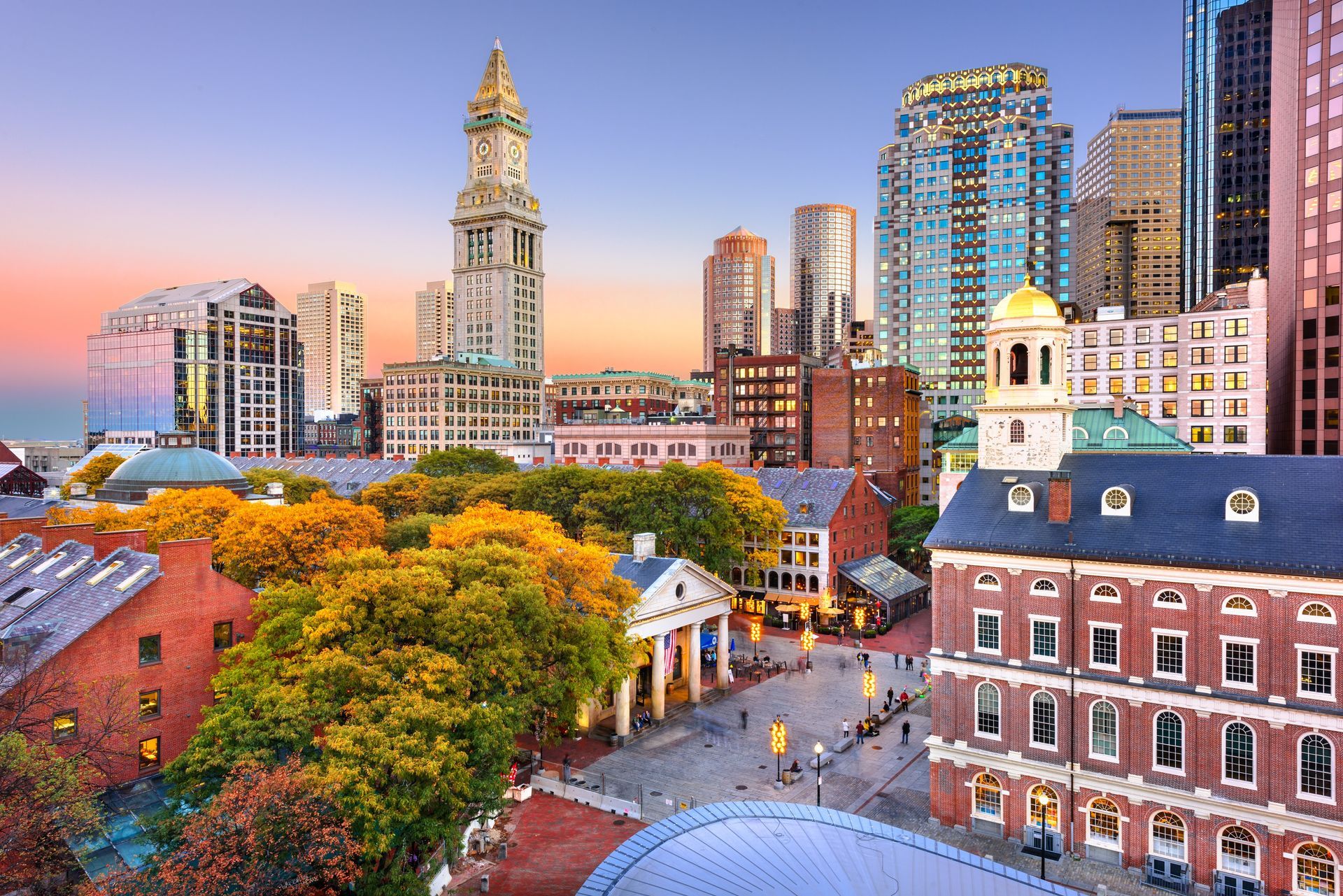 Historic city skyline of Boston at sunset with colourful autumn trees and brick buildings