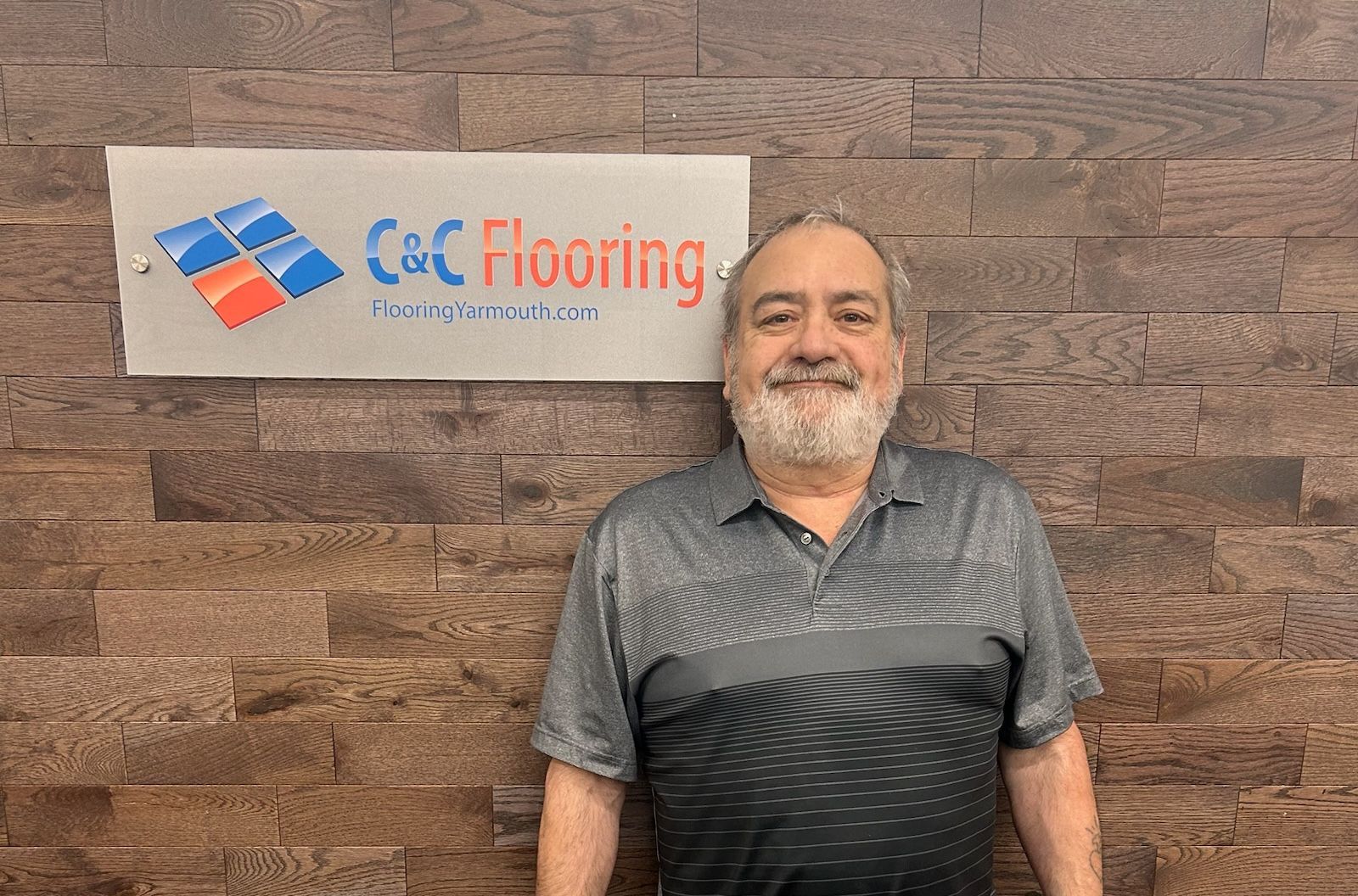 A silhouette of a man without a face on a gray background.