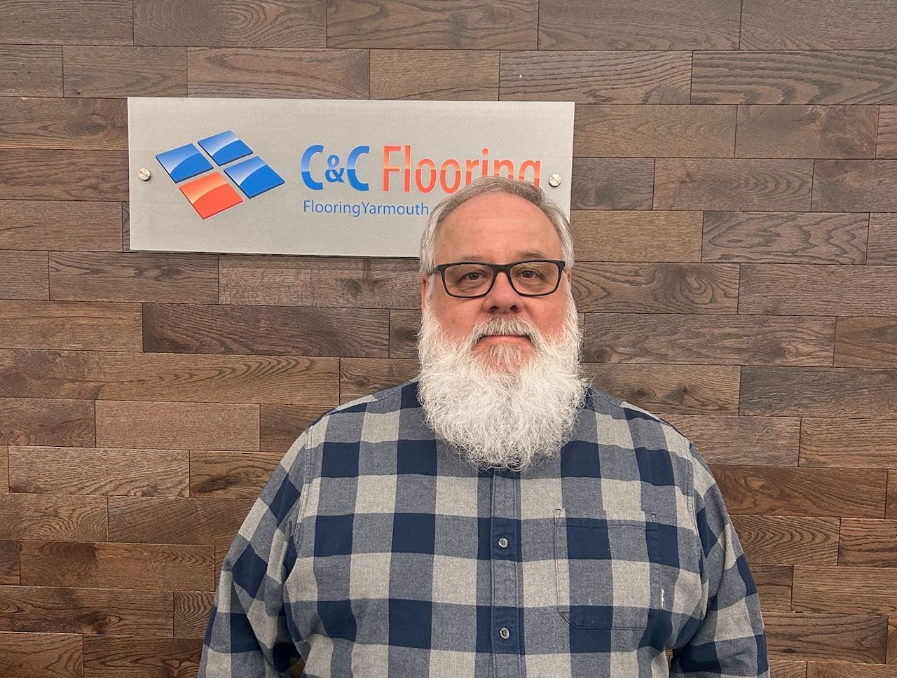 A silhouette of a man without a face on a gray background.